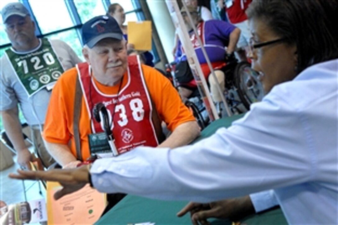 Jack Kesgard, center, a 72-year-old Air Force veteran, registers for the 23rd Annual National Veterans Golden Age Games, June 1, 2009, in Birmingham, Ala. Nearly 700 senior veterans ages 55 and older registered to participate in the athletic competitions here.