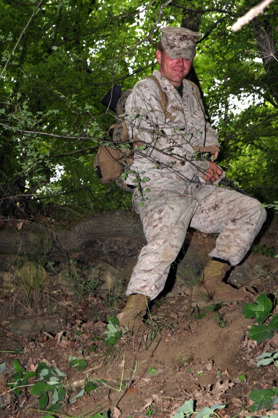 Lance Cpl. Jason Palendrano, a team leader with Kilo Company, Battalion Landing Team, 3rd Battalion, 2nd Marine Regiment, 22nd Marine Expeditionary Unit and a native of Keyport, N.J., slides down an embankment during a squad competition aboard the Nova Selo Training Area in Sliven, Bulgaria, June 1, 2009. Kilo Co. Marines are in Bulgaria to conduct training at the joint Bulgarian-American training base. This is the first time U.S. Marines have conducted this kind of training in Bulgaria. The 22nd MEU is currently serving as the theater reserve force for U.S. European Command. ::r::::n::(Official Marine Corps photo by Cpl. Justin M. Martinez)::r::::n::