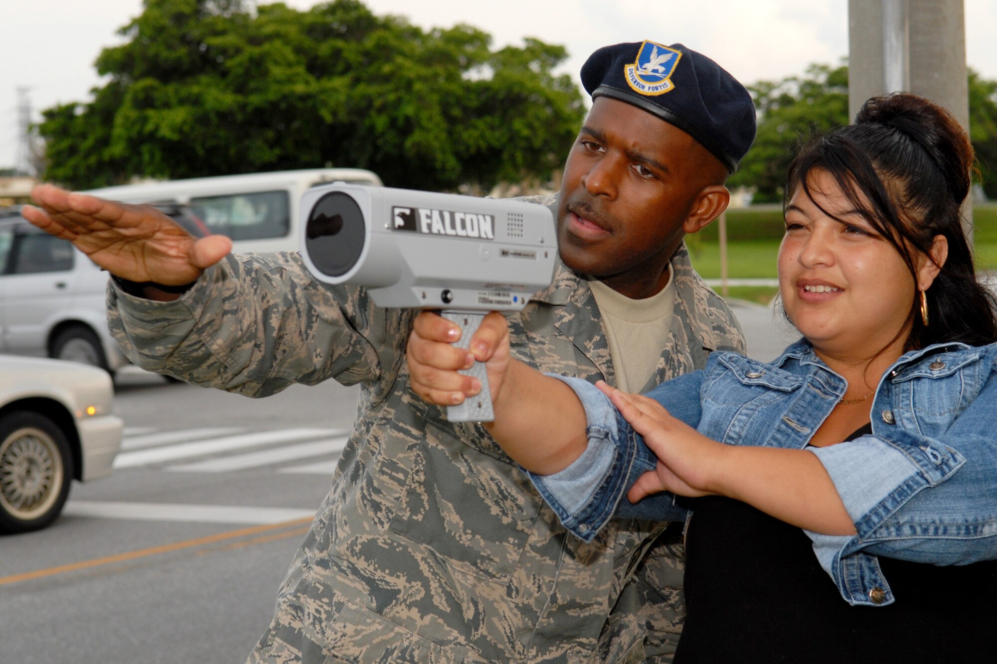 Tech. Sgt. Ronald Keeve, a member of the 18th Security Forces Squadron, instructs Army spouse Vanessa Chavez on the use of a speed detecting radar gun during the "Civilian Police Academy" course at Kadena, May 27.
(U.S. Air Force photo/Tech. Sgt. Angelique Perez) 