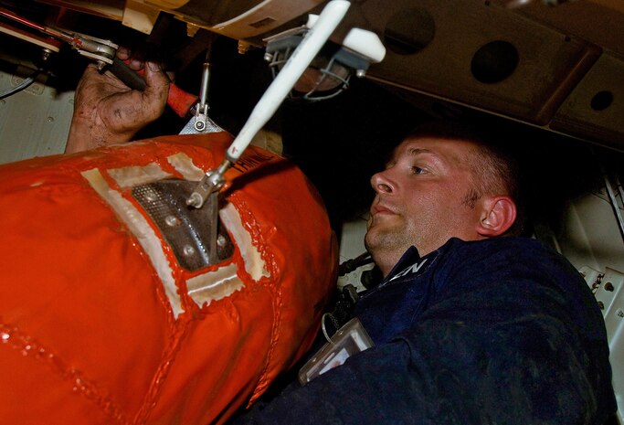 Tech. Sgt. Ken Jones installs a new heat exhaust boot in the air conditioner compartment of a C-17 here June 1. The exhaust boot required replacement after the previous boot was severely torn, causing an air flow leak and disabling of the air pre-cooling system. Sergeant Jones is an electrical and environmental specialist with the 315th Maintenance Squadron. (U.S. Air Force photo/Staff Sgt. Daniel Bowles)