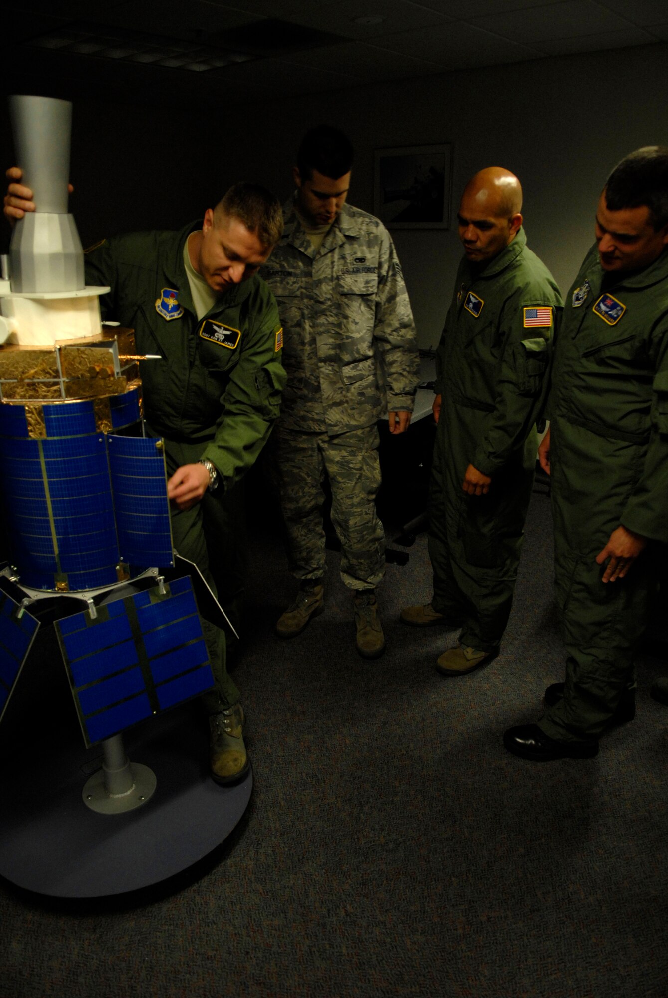 VANDENBERG AIR FORCE BASE, Calif. -- Staff Sgt. Dan St. James, a 533rd Training Squadron Space Based Infared Systems instructor, explains the sub systems of defense support program satellites to students May 28. The students must understand the inner workings of a satellite in order to provide better understanding of how they get their mission data. The 533rd TRS, an original missile squadron and a training detachment at Schriever AFB, Colo., provides initial qualification training for attack warning, space surveillance and counterdrug missions. (U.S. Air Force photo/Senior Airman Christian Thomas)
