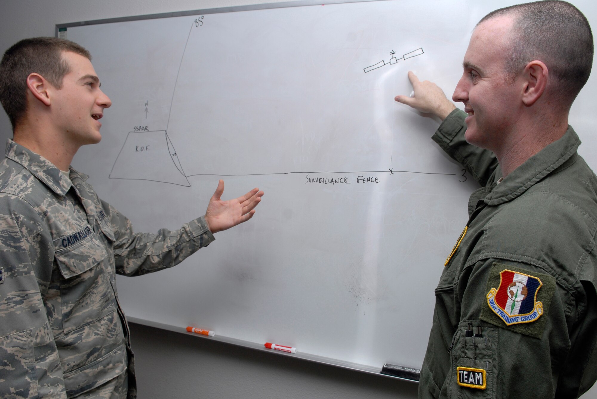 VANDENBERG AIR FORCE BASE, Calif. --  Tech. Sgt. Cory Beebe, a 533rd Training Squadron enlisted Space 100 instructor, explains to Airman 1st Class Andrew Cadwallader, a 533rd TRS student, how ground based radars track satellites May 27.   The 533rd TRS, an original missile squadron and a training detachment at Schriever AFB, Colo., provides initial qualification training for attack warning, space surveillance and counterdrug missions. (U.S. Air Force photo/Senior Airman Christian Thomas)