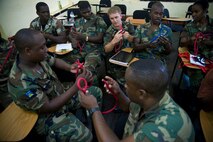 Senior Airman Blair Baerny teaches knot tying to the Royal St. Lucia police force's special service unit during a subject matter expert exchange June 1 at La Toc, St. Lucia. Senior Airman Baerny is a pararescueman and member of a Guardian Angel team deployed to Operation Southern Partner. He is assigned to the 58th Rescue Squadron from Nellis Air Force Base, Nev. (U.S. Air Force photo/Staff Sgt. Bennie J. Davis III)