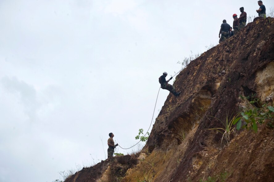 Members of the Operation Southern Partner Guardian Angel team teach basic mountaineering skills for high angle rope rescue to the Royal St. Lucia police force's special service unit June 1 during a subject matter expert exchange at La Toc, St. Lucia. (U.S. Air Force photo/Staff Sgt. Bennie J. Davis III)
