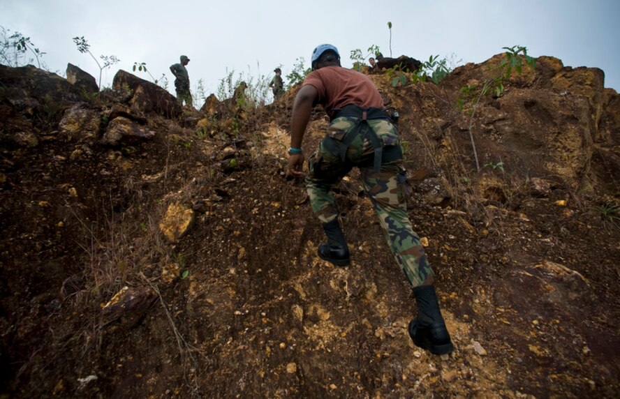 Members of the Royal St. Lucian police force's special wervice unit make their way up a step incline to execute basic mountaineering rescue procedures learned during Operation Southern Partner June 1 at La Toc, St. Lucia. (U.S. Air Force photo/Staff Sgt. Bennie J. Davis III)