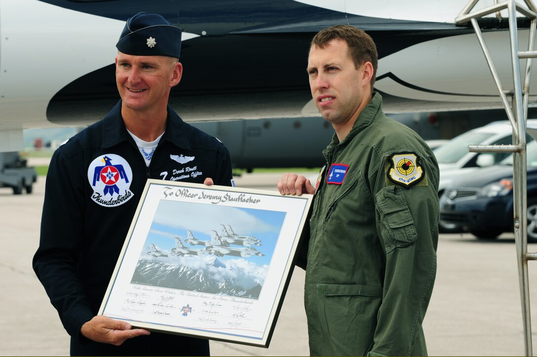Lt. Col. Derek Routt, U.S. Air ForceThunderbirds operations officer (left), presents Jeremy Stauffacher, Rapid City Police Department officer, a lithograph signed by the Thunderbird members for being the Hometown Hero here, May 30.  The Hometown Hero program is designed to highlight someone from the local area who has given of themselves to better the community. (U.S. Air Force photo/Senior Airman Anthony Sanchelli)