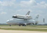 The space shuttle Atlantis sits atop a modified 747 after landing at Lackland's Kelly Field Annex June 2. The shuttle is being ferried from Edwards Air Force Base, Calif., back to Florida after a 13-day mission in space to repair and upgrade the Hubble Space Telescope. (U.S. Air Force photo/Alan Boedeker)                                                               