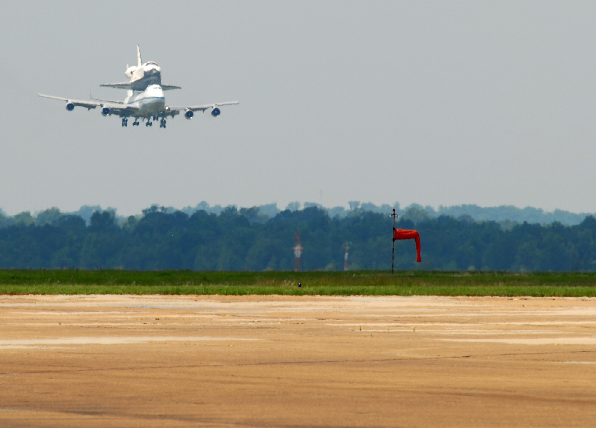 The Space Shuttle Atlantis, riding atop a modified Boeing 747 Shuttle Carrier Aircraft, makes its final approach before landing at Columbus Air Force Base June 2. Columbus AFB was the shuttle’s final stop for fuel before finishing its journey to Kennedy Space Center, Fla. (U.S. Air Force photo/Melissa Duncan). 