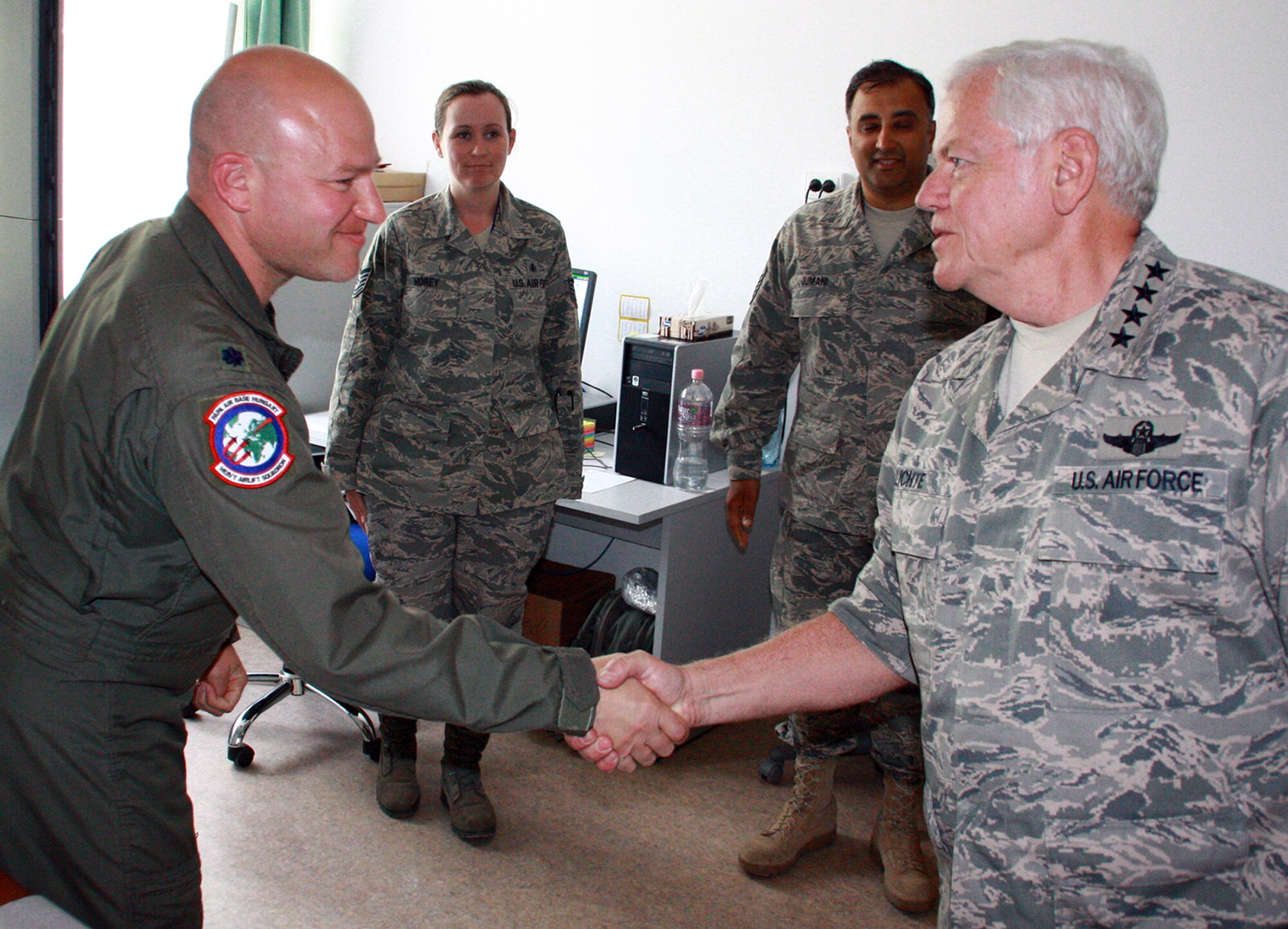General Arthur Lichte, commander of Air Mobility Command, meets Lt. Col. Pete Sipos, Heavy Airlift Wing flight surgeon, while Master Sgt. Rustam Jumani (right) and Tech. Sgt. Michelle Morey, both medical technicians supporting the HAW, look on.  The Heavy Airlift Wing, the operational-level unit of the Strategic Airlift Capability consortium of 10 NATO and two Partnership for Peace nations, is preparing for its official activation and the arrival of the first of its three C-17 Globemaster IIIs July 27.  (Photo by Capt. Juha Miettinen/Finnish Air Force)