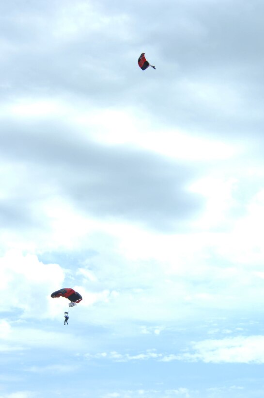 The U.S. Army Black Daggers parachute during the Dakota Thunder open house and air show here, May 30. The event featured multiple static displays as well as aerial demonstrations from the U.S. Air Force Thunderbirds and the West A-10 Demo team. (U.S. Air Force photo by Airman 1st Class Corey Hook)
