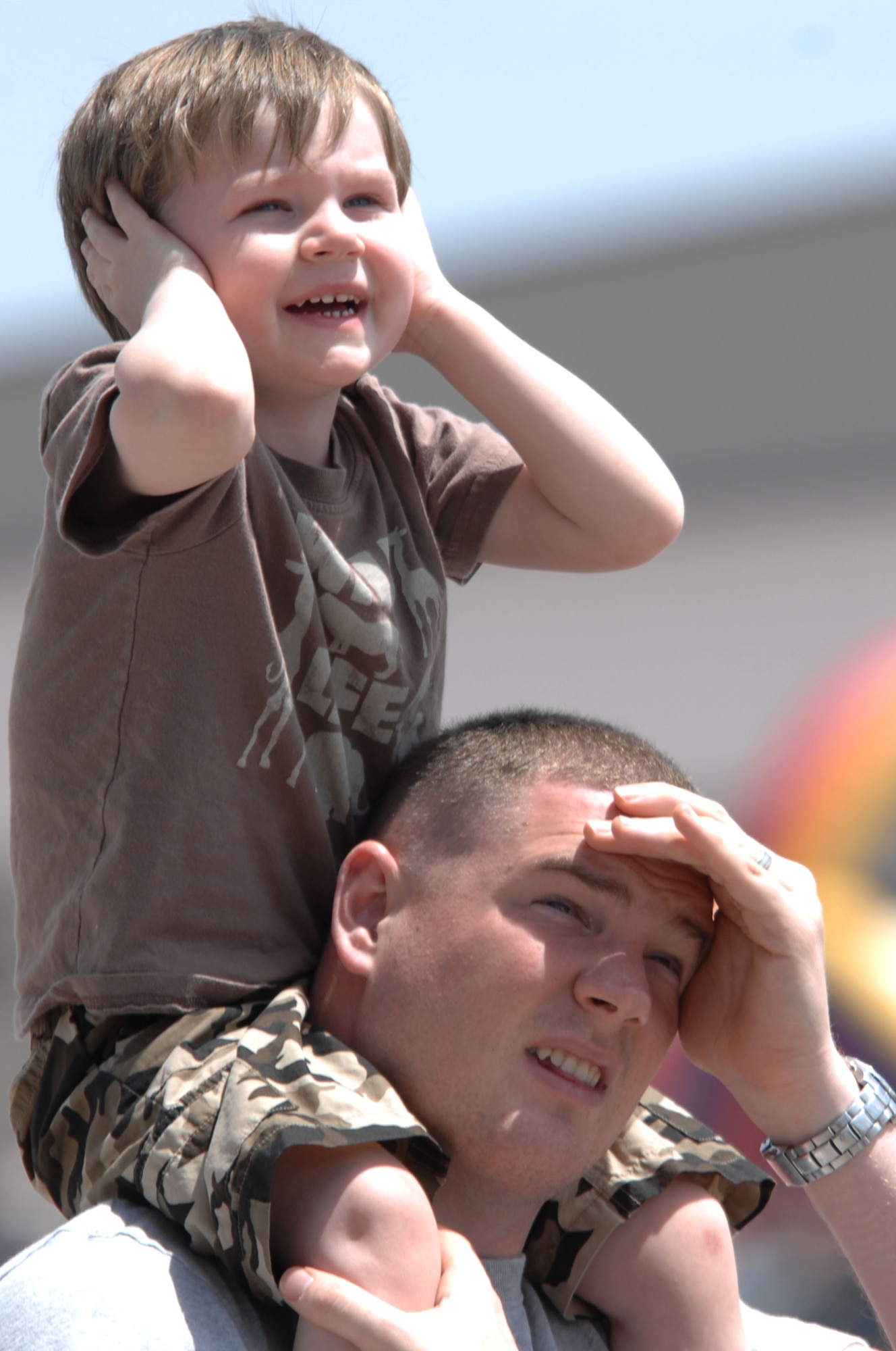(Bottom) Marc Reed and his son, Connor Reed, watch as the A-10 Thunderbolt ll flies by at the Dakota Thunder open house and air show here, May 30. The event featured multiple static displays as well as aerial demonstrations from the U.S. Air Force Thunderbirds and the U.S. Army Black Daggers parachute demonstration team. (U.S. Air Force photo by Airman 1st Class Corey Hook)