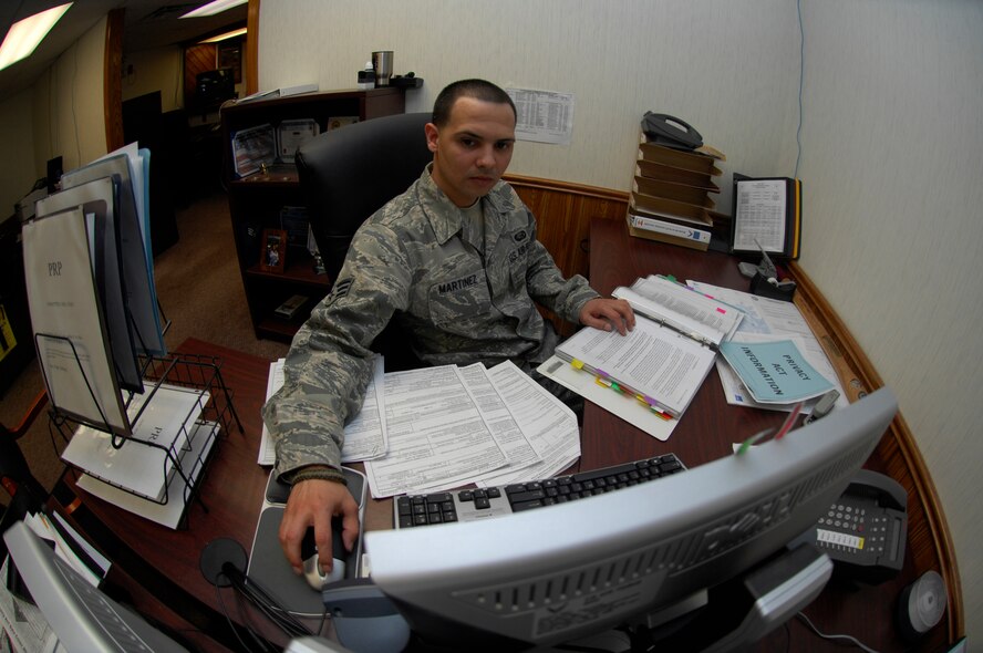 MINOT AIR FORCE BASE, N.D. -- Senior Airman Herminio Martinez, base Personal Reliability Program monitor meticulously tracks and monitors the entire base population of members on the PRP program. The PRP program is designed to ensure that each member who performs duties involving nuclear weapons meet certain criteria to guarantee the safety, security and reliability of nuclear asset.  (U.S. Air force Photo by Staff Sergeant Stacy Moless)