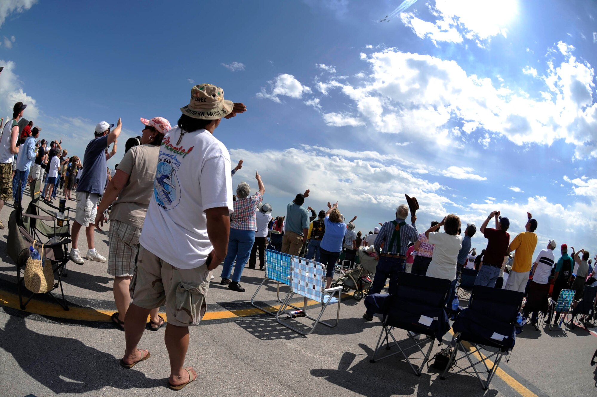 A crowd of spectators watch as the Thunderbirds, the U.S. Air Force Air Demonstration Squadron, fly here during the Dakota Thunder open house and air show, May 31. The air show is a way the military thanks the public for their support and it serves as a recruiting tool. (U.S. Air Force photo by Airman 1st Class Corey Hook)
