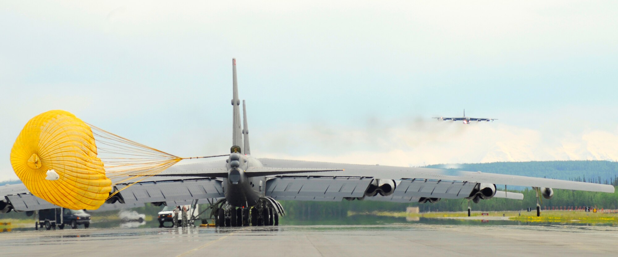 Two B-52 Stratofortresses from Barksdale AFB, La. rest on the flightline as another B-52 prepares for a landing at Eielson Air Force Base, Alaska, May 31, 2009 in support of Northern Edge 2009.  Northern Edge is Alaska's largest military training excercise. The exercise is held over a two-week period, involving components from the Army, Marines, Navy, and Air Force. (U.S. Air Force photo/Staff Sgt. Tia Wilson) 