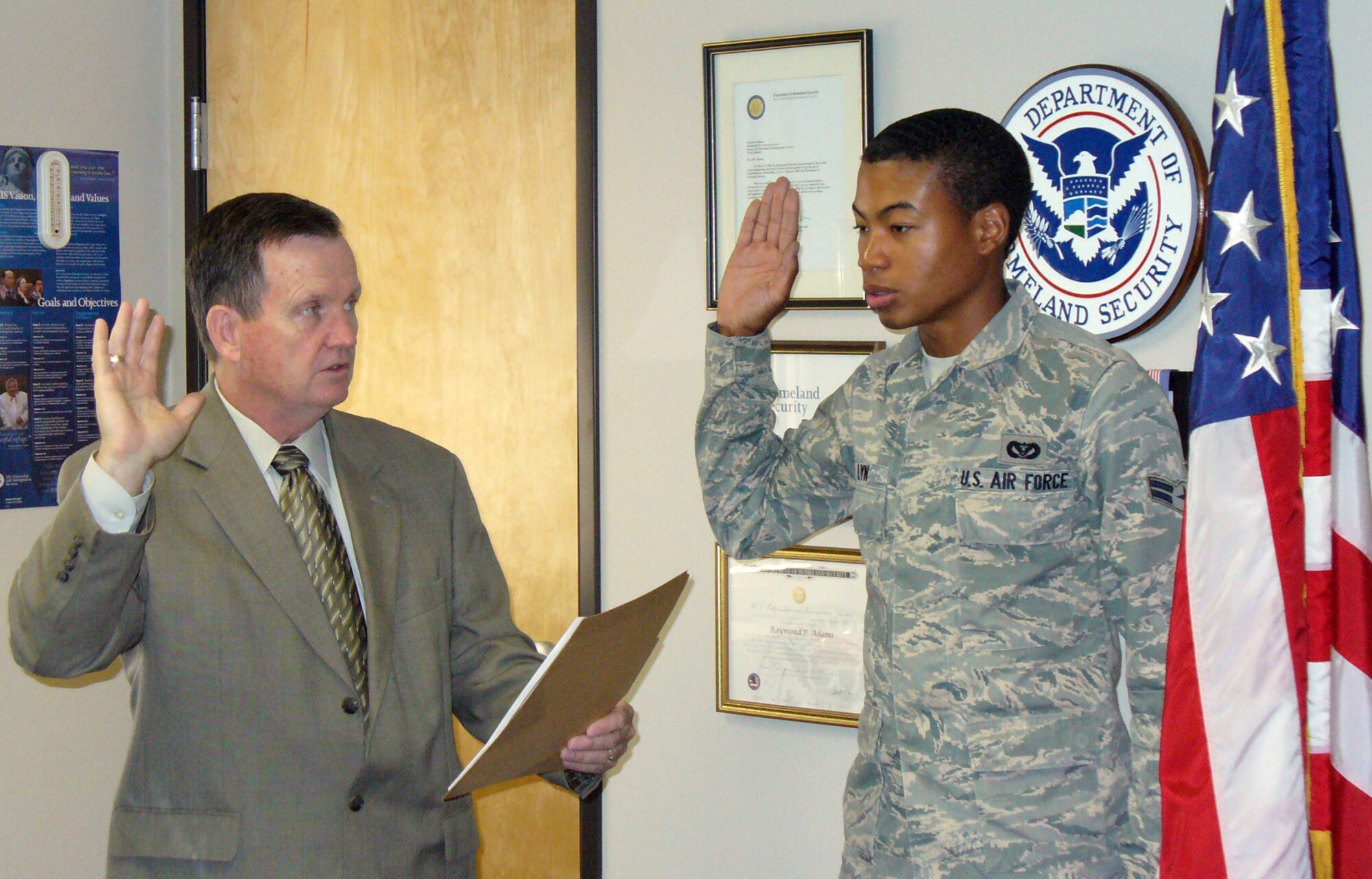 Airman 1st Class Christopher Lyn, from the 49th Materiel Maintenance Squadron at Holloman Air Force Base, N.M., recieves the Oath of Allegiance from El Paso Field Office Director, Raymond P. Adams. Originally from Jamaica, Airman Lyn was the 30th member of the military naturalized by U.S. Citizenship and Immigration Services? (USCIS) El Paso Field Office during May 2009. USCIS? month-long military naturalization initiative was in recognition of National Military Appreciation Month. (Photo provided)
