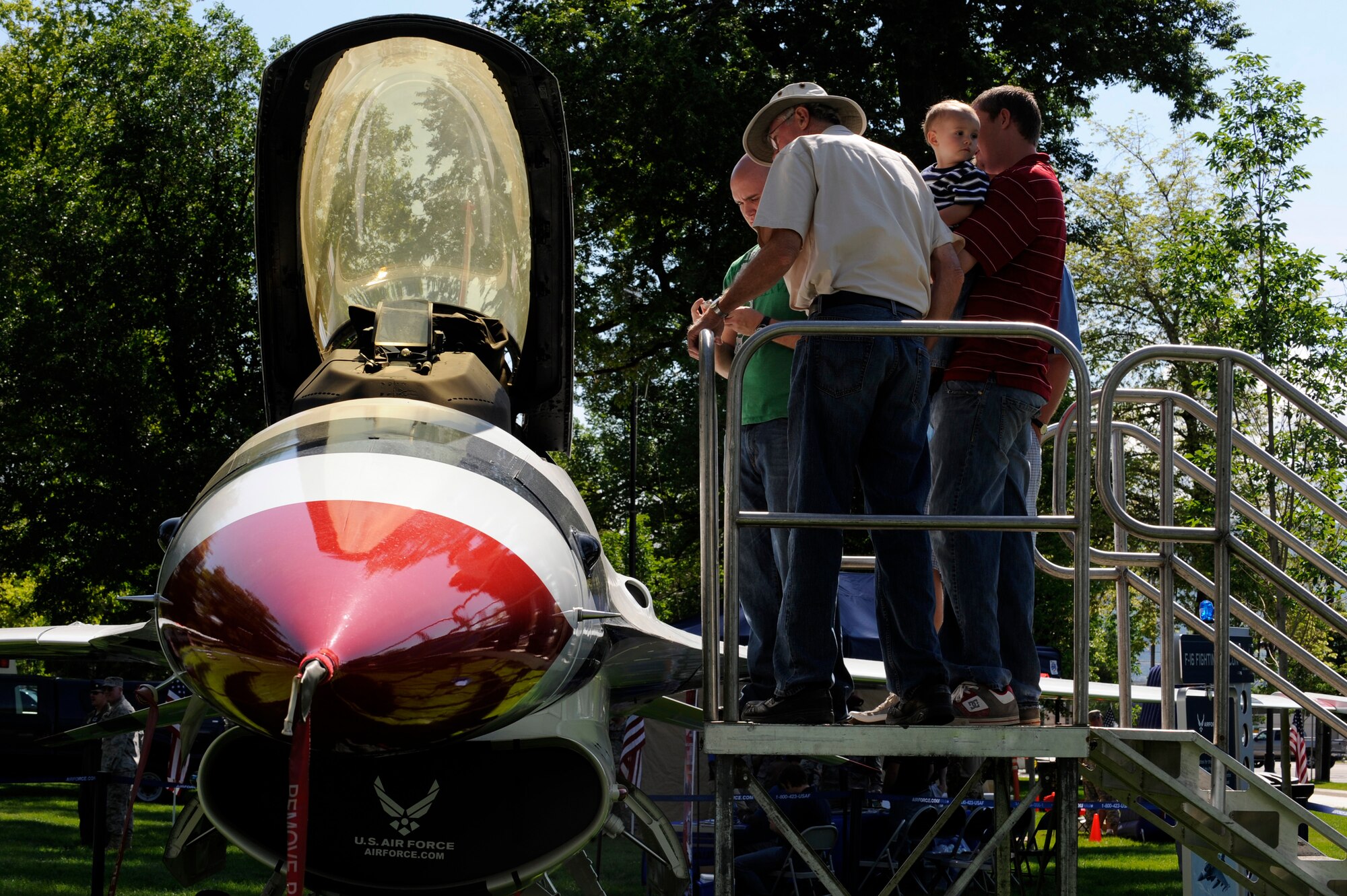 Salt Lake City locals check out an F-16 Fighting Falcon on display at the "Our Nation's Defenders Showcase" at Pioneer Park for Air Force Week Salt Lake City June 2. The showcase includes many Air Force booths, displays and performances by the band "Max Impact," a performance unit with the United States Air Force Band from Bolling Air Force Base, Washington, D.C.  Air Force Week-Salt Lake City is Jun. 1 to 7 and has events throughout the area. (U.S. Air Force photo/Staff Sgt. Desiree N. Palacios)