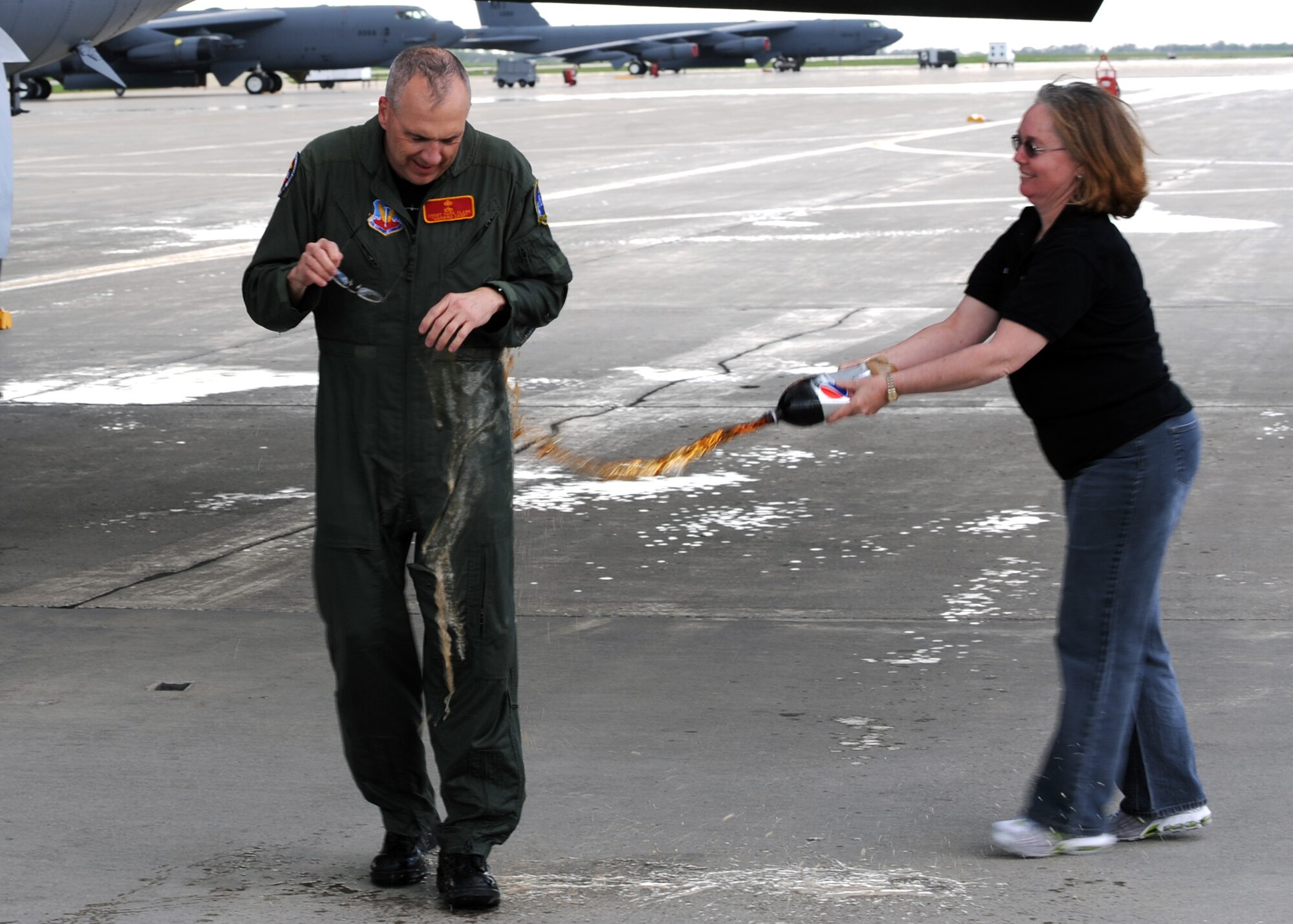 MINOT AIR FORCE BASE, ND – Chief Master Sgt. Mark Clark, 5th Bomb Wing Command Chief, is sprayed down by his wife Linda after his final B-52H Stratofortress flight here, May 28. Chief Clark is retiring from active duty after 30 years of service in the Air Force on Jun 19.