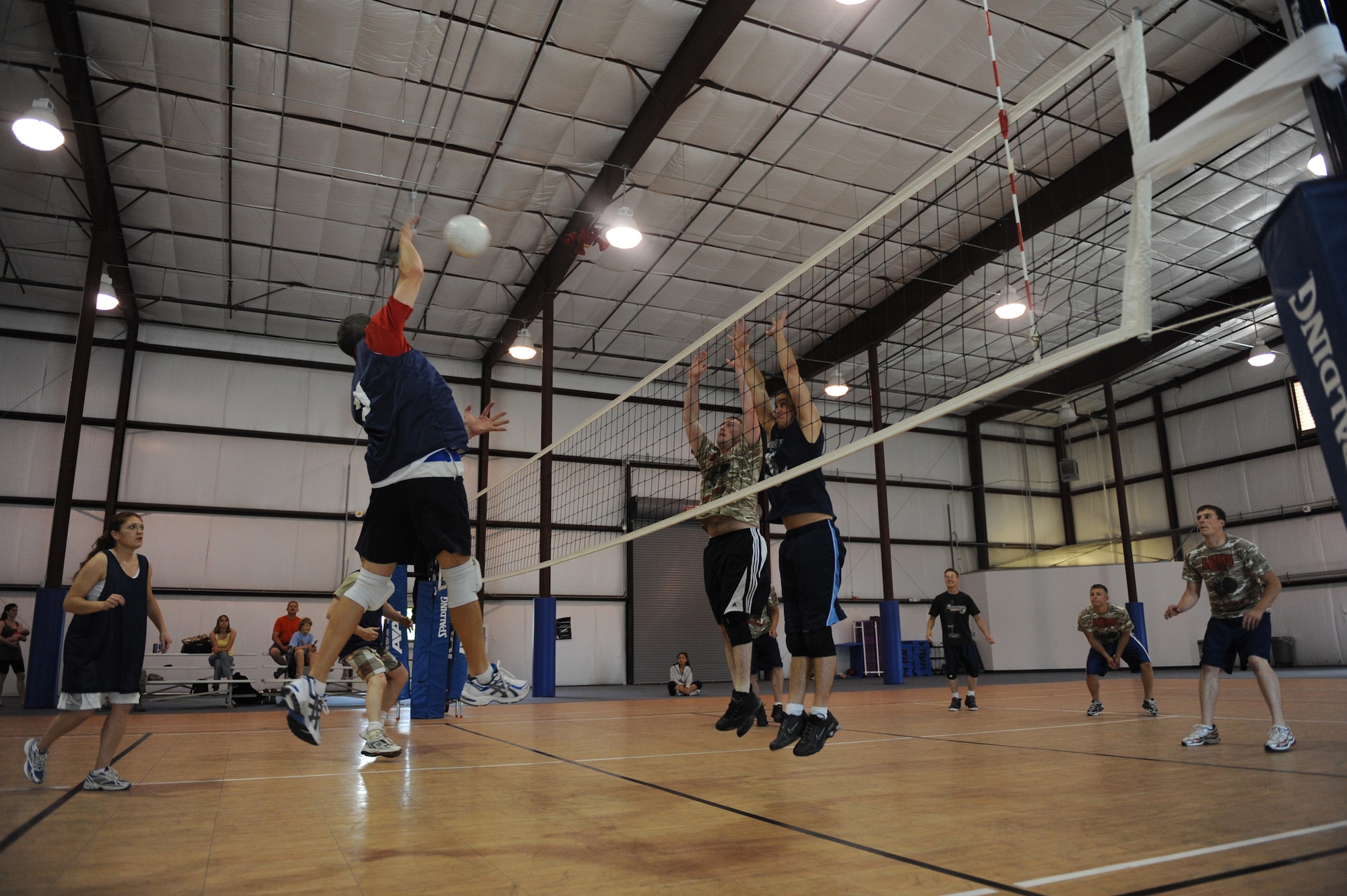 MOUNTAIN HOME AIR FORCE BASE, Idaho – Mike Hurt (left), 366th Force Support Squadron A-team, tries to spike the ball over two 366th Equipment Maintenance Squadron ammunitions flight defenders during the base volleyball championship game May 28. The 366th FSS won two out of three games to claim the championship. (U.S. Air Force photo/ Airman 1st Class Renishia Richardson)