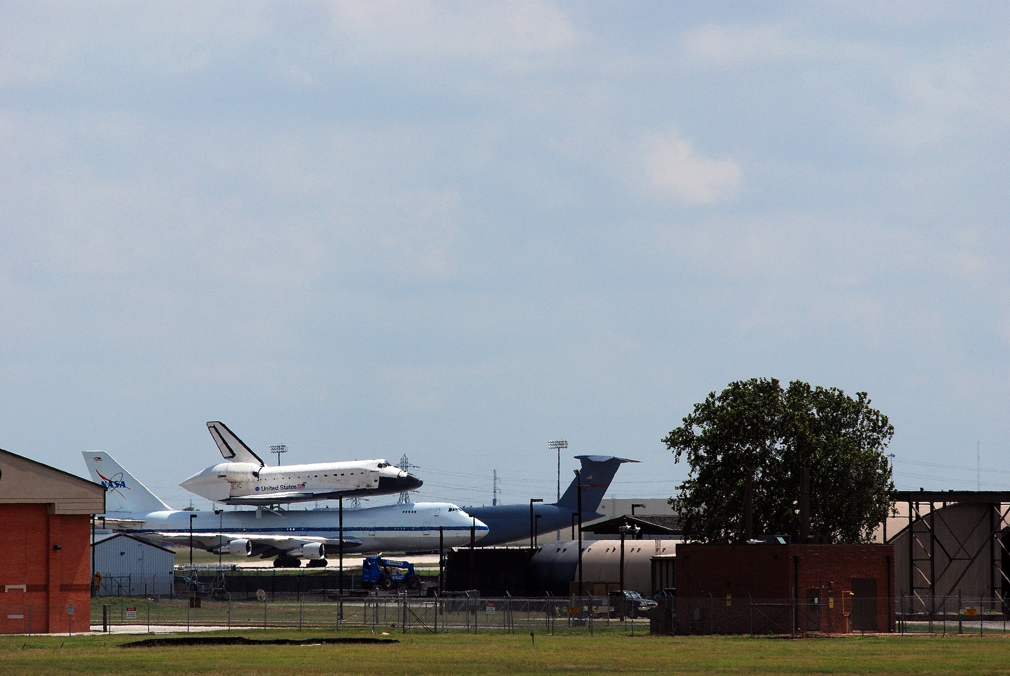 Space Shuttle Atlantis made a pit-stop, to a parking area near the 433rd Airlift Wing at Lackland AFB, Texas, today (June 2, 2009). The shuttle is on its way home to Kennedy Space Center, Fla., from the landing site at Edwards AFB, Calif. According to Ms. Candrea Thomas, public affairs officer at NASA's Kennedy Space Center, Atlantis was returning from "STS Mission 125" where the crew serviced and upgraded the Hubble Space Telescope on the International Space Station. Weather caused a delay and relocation of the landing site. After landing at Edwards AFB, Atlantis was "piggybacked" onto a modified Boeing 747 called a shuttle carrier. The 747 then flew from Edwards to El Paso, Texas and spent the night waiting for severe thunder storms to pass. Next stop was the Lackland AFB flight line. The shuttle carrier took on fuel while parked near the Alamo Wing"s C-5 Galaxy parking ramp. From here, the shuttle plans a stop in Columbus, Ohio and is expected back in Florida early in the evening.  (U.S. Air Force Photo/Airman Brian McGloin)