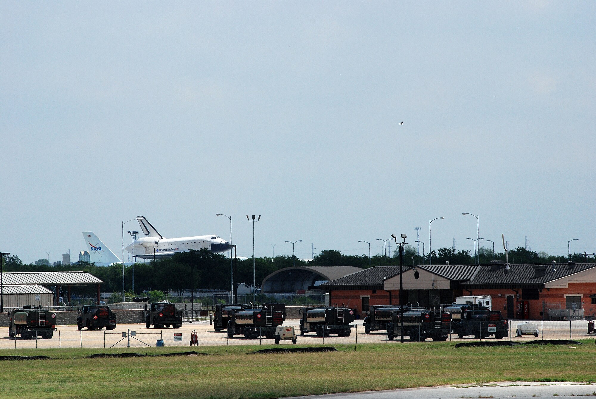 Space Shuttle Atlantis made a pit-stop, to a parking area near the 433rd Airlift Wing at Lackland AFB, Texas, today (June 2, 2009). The shuttle is on its way home to Kennedy Space Center, Fla., from the landing site at Edwards AFB, Calif. According to Ms. Candrea Thomas, public affairs officer at NASA's Kennedy Space Center, Atlantis was returning from "STS Mission 125" where the crew serviced and upgraded the Hubble Space Telescope on the International Space Station. Weather caused a delay and relocation of the landing site. After landing at Edwards AFB, Atlantis was "piggybacked" onto a modified Boeing 747 called a shuttle carrier. The 747 then flew from Edwards to El Paso, Texas and spent the night waiting for severe thunder storms to pass. Next stop was the Lackland AFB flight line. The shuttle carrier took on fuel while parked near the Alamo Wing"s C-5 Galaxy parking ramp. From here, the shuttle plans a stop in Columbus, Ohio and is expected back in Florida early in the evening.  (U.S. Air Force Photo/Airman Brian McGloin)