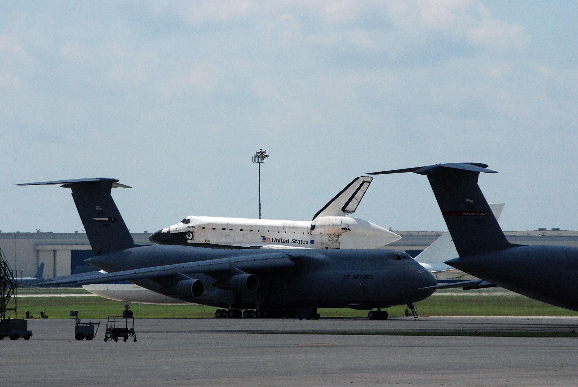 Space Shuttle Atlantis made a pit-stop, to a parking area near the 433rd Airlift Wing at Lackland AFB, Texas, today (June 2, 2009). The shuttle is on its way home to Kennedy Space Center, Fla., from the landing site at Edwards AFB, Calif. According to Ms. Candrea Thomas, public affairs officer at NASA"s Kennedy Space Center, Atlantis was returning from "STS Mission 125" where the crew serviced and upgraded the Hubble Space Telescope on the International Space Station. Weather caused a delay and relocation of the landing site. After landing at Edwards AFB, Atlantis was "piggybacked" onto a modified Boeing 747 called a shuttle carrier. The 747 then flew from Edwards to El Paso, Texas and spent the night waiting for severe thunder storms to pass. Next stop was the Lackland AFB flight line. The shuttle carrier took on fuel while parked near the Alamo Wing"s C-5 Galaxy parking ramp. From here, the shuttle plans a stop in Columbus, Ohio and is expected back in Florida early in the evening.  (U.S. Air Force Photo/Airman Brian McGloin)