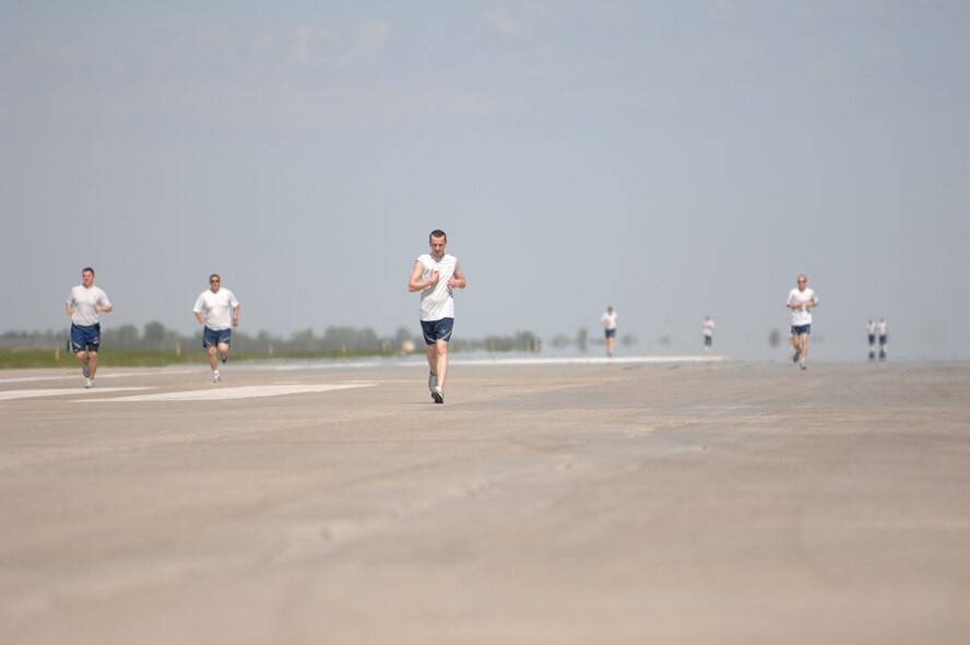 Airmen from the base participate in a 1.5 mile fitness run on the runway here May 29. The runway run is scheduled periodically by the health and wellness center in the spring and summer to promote physical fitness and team building. (U.S. Air Force photo by Staff Sgt. Angel Gallardo)