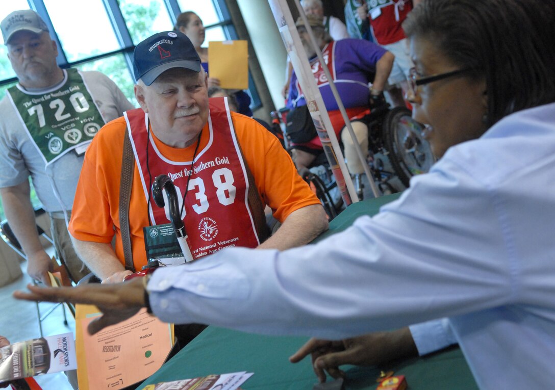 Jack Kesgard (center), a 72-year-old Air Force veteran, registers for the 23rd Annual National Veterans Golden Age Games June 1 in Birmingham, Ala. Nearly 700 senior veterans, ages 55 and older, registered to participate in the athletic competitions here.  (Defense Department photo/Army Sgt. 1st Class Michael J. Carden)