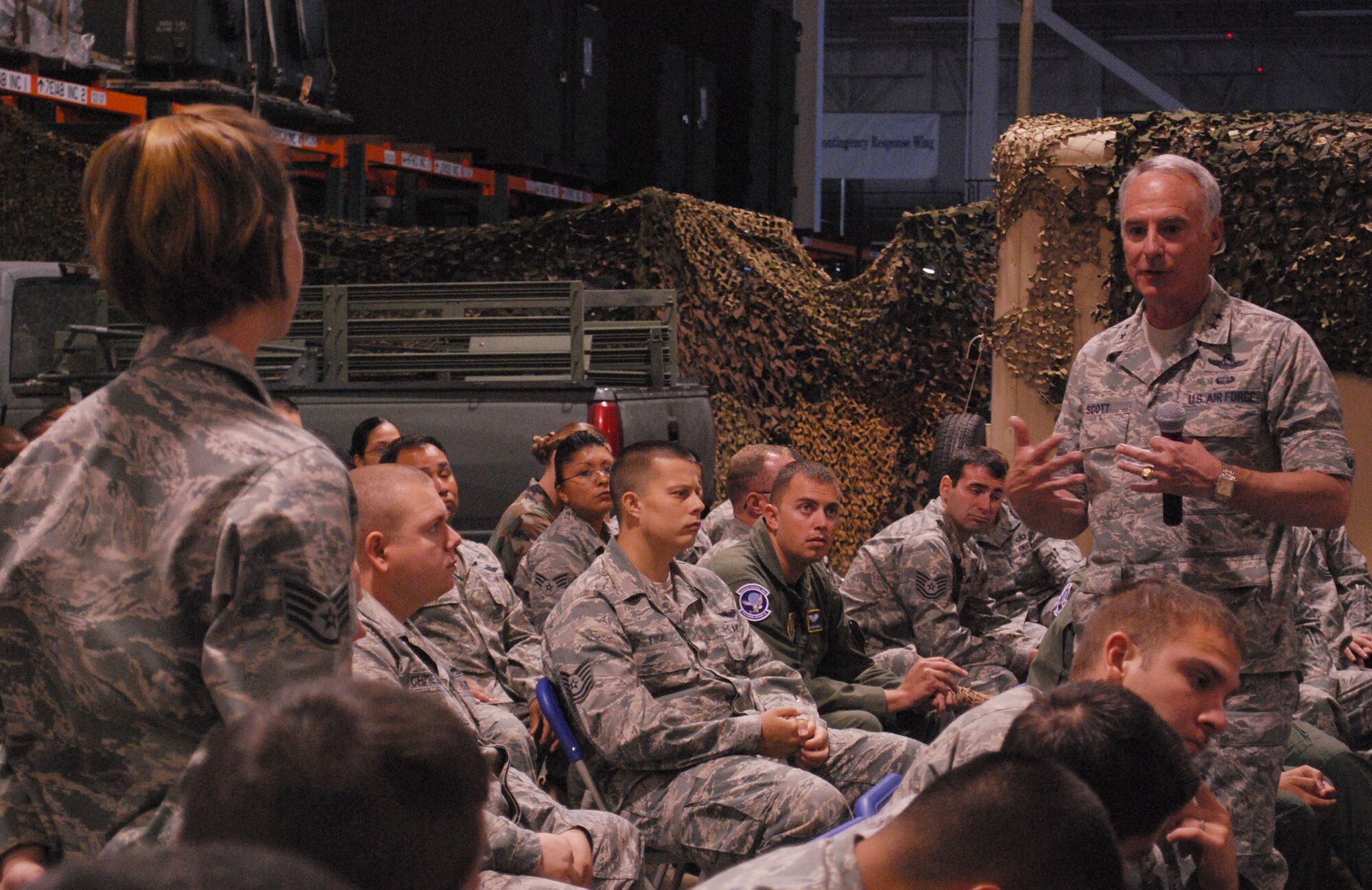 Maj. Gen. Winfield Scott III, 18th Air Force commander, responds to a question from Staff Sgt. Amy Anconetani, 573rd Global Support Squadron, during a 615th Contingency Response Wing Airmen’s Call May 27.  The general visited the wing May 26-27 and received an in-depth look at the wing’s myriad capabilities through one-on-one briefings with some of the organization’s elite warrior Airmen and answered questions during an Airmen’s Call May 27.  After visiting the 615th CRW, the general traveled to Hickam Air Force Base, Hawaii, to visit the 515th Air Mobility Operations Wing – the 615th CRW’s sister wing within the 15th Expeditionary Mobility Task Force. (U.S. Air Force photo/1st Lt. Nicole Langley) 