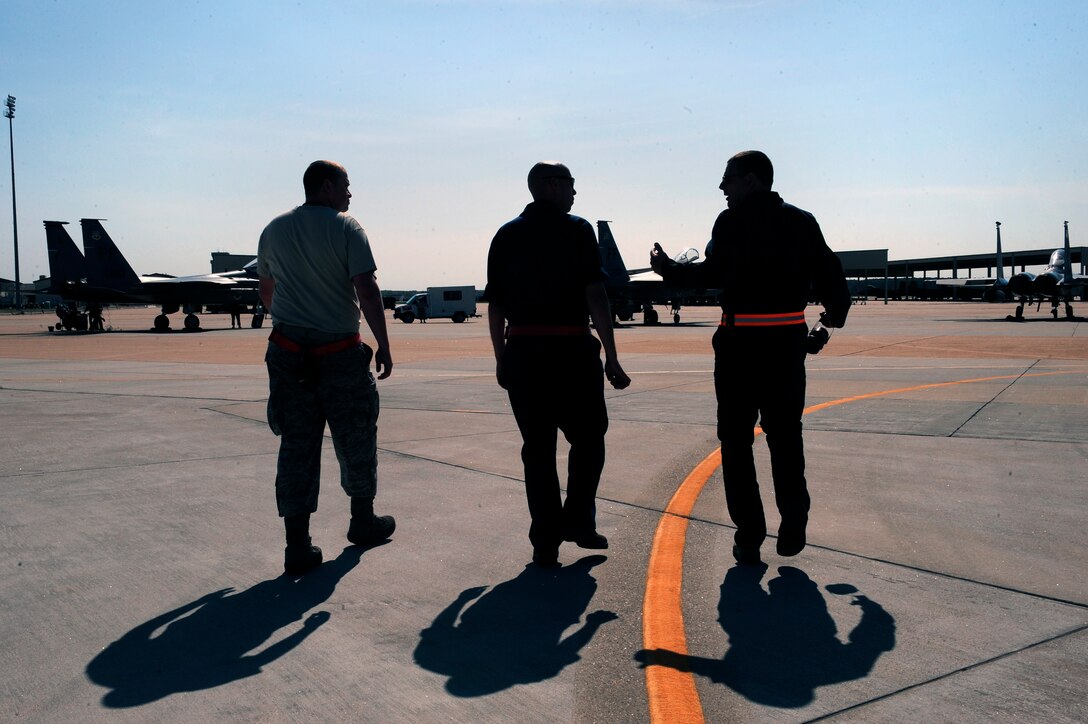 LANGLEY AIR FORCE BASE, Va. -- 1st Fighter Wing Command Chief Master Sgt. Kevin Slater walks alongside Staff Sgt. Tim Knighting, 71st Aircraft Maintenance Unit F-15 crew chief, and Staff Sgt. Jacob Chamberlain, 71st AMU F-15 avionics specialist, during a visit to to better understand the day-to-day challenges faced by the maintainers.  Chief Slater spent the afternoon with maintainers from the 71st Aircraft Maintenance Unit here June 1.  (U.S. Air Force photo/Senior Airman Vernon  Young)