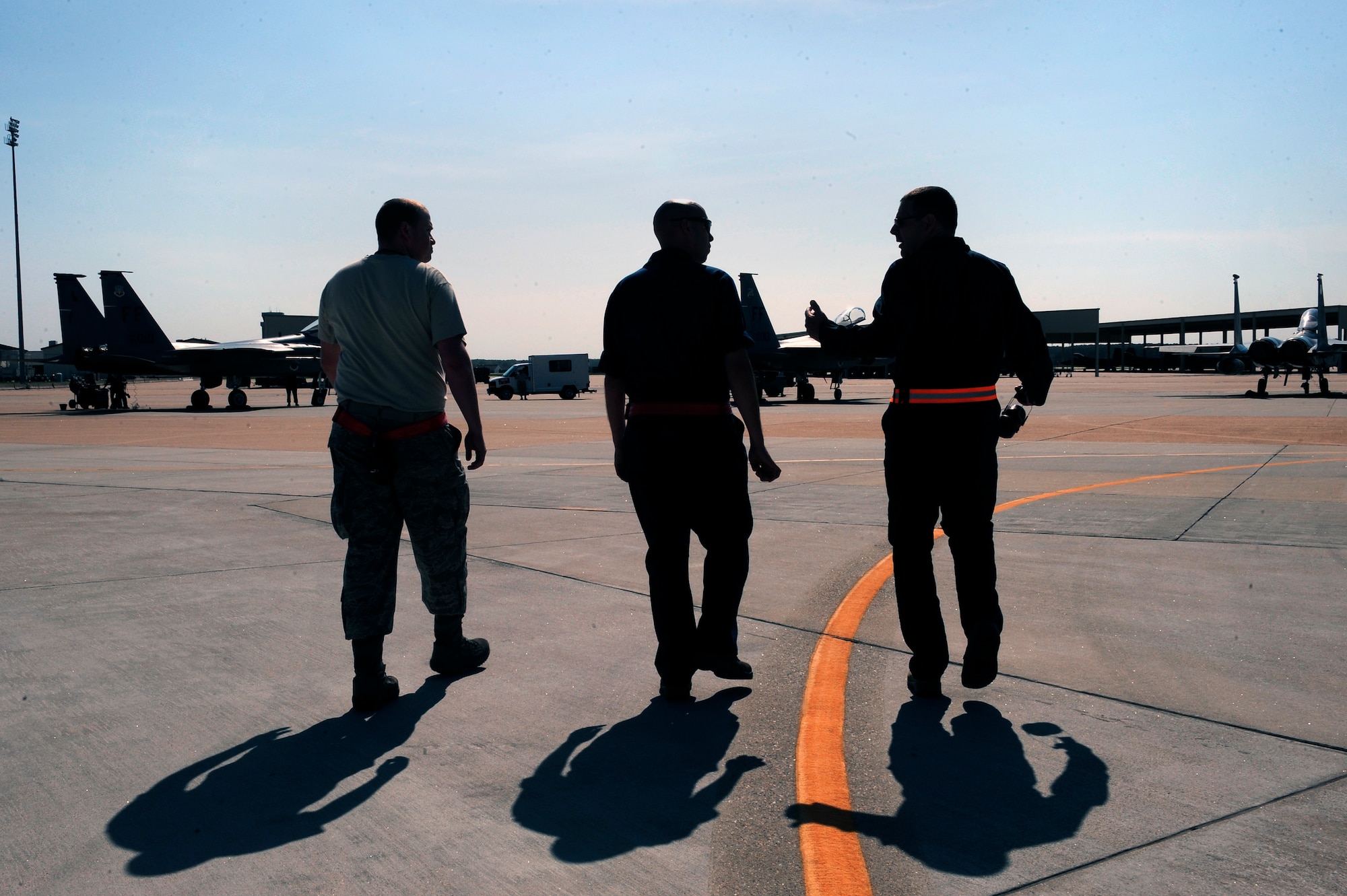 LANGLEY AIR FORCE BASE, Va. -- 1st Fighter Wing Command Chief Master Sgt. Kevin Slater walks alongside Staff Sgt. Tim Knighting, 71st Aircraft Maintenance Unit F-15 crew chief, and Staff Sgt. Jacob Chamberlain, 71st AMU F-15 avionics specialist, during a visit to to better understand the day-to-day challenges faced by the maintainers.  Chief Slater spent the afternoon with maintainers from the 71st Aircraft Maintenance Unit here June 1.  (U.S. Air Force photo/Senior Airman Vernon  Young)