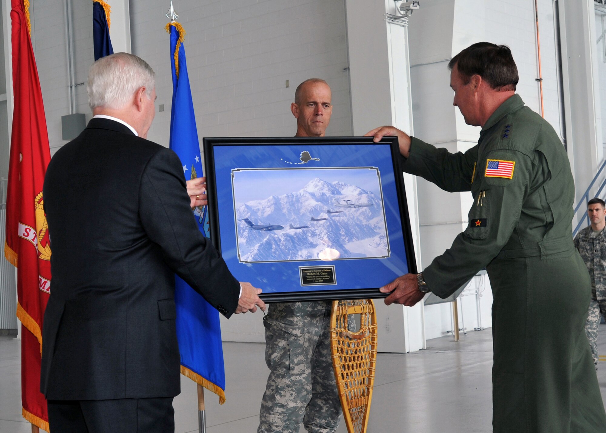 ELMENDORF AIR FORCE BASE, Alaska -- Lt. Gen. Dana T. Atkins, Alaskan Command and 11th Air Force commander, gives a gift to Secretary of Defense Robert M. Gates in recognition of speaking to the troops during a town hall meeting here June 1, 2009. Secretary Gates came to Elmendorf to discuss with military members how the war is affecting this base and their everyday lives. (U.S. Air Force/Senior Airman Laura Turner)