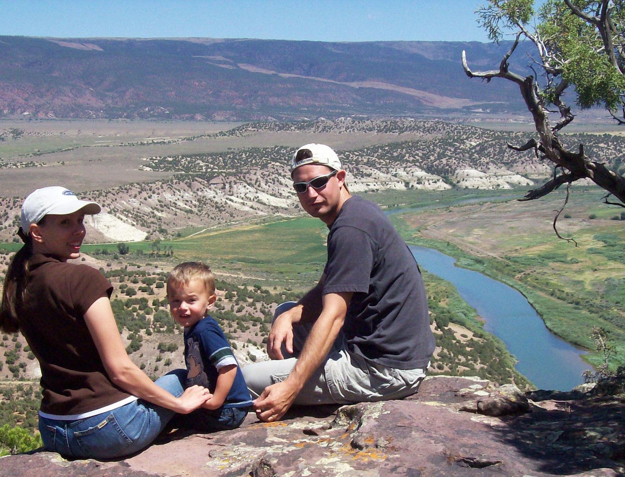 Senior Airman Eric Slaugh, his wife, Marcie, and his son, Skyler, enjoy the view of the Green River in Wyoming during a family vacation. Airman Slaugh, assigned to the 27th Special Operations Component Maintenance Squadron at Cannon Air Force Base, N.M., used his self-aid and buddy care training to assist a man hit by a train in December 2008. (Courtesy photo) 
