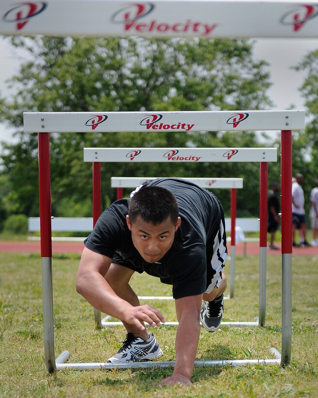 LANGLEY AIR FORCE BASE, Va. -- Airman 1st Class Jee Nou Xiong, 1st Contracting Squadron contract specialist, crawls through the obstacle course station of a Velocity class here May 29. Certified representatives from Velocity led a physical conditioning class geared toward improving overall physical performance in support of May fitness month.  (U.S. Air Force photo/Senior Airman Vernon Young)