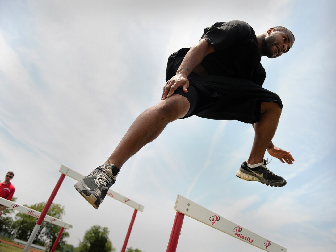 LANGLEY AIR FORCE BASE, Va. -- Staff Sgt. James Beck, 27th Fighter Squadron avionics resource manager, hurdles during the obstacle course station of a Velocity class here May 29. Certified representatives from Velocity led a physical conditioning class geared toward improving overall physical performance in support of May fitness month.  (U.S. Air Force photo/Senior Airman Vernon Young)