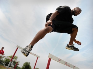 LANGLEY AIR FORCE BASE, Va. -- Staff Sgt. James Beck, 27th Fighter Squadron avionics resource manager, hurdles during the obstacle course station of a Velocity class here May 29. Certified representatives from Velocity led a physical conditioning class geared toward improving overall physical performance in support of May fitness month.  (U.S. Air Force photo/Senior Airman Vernon Young)