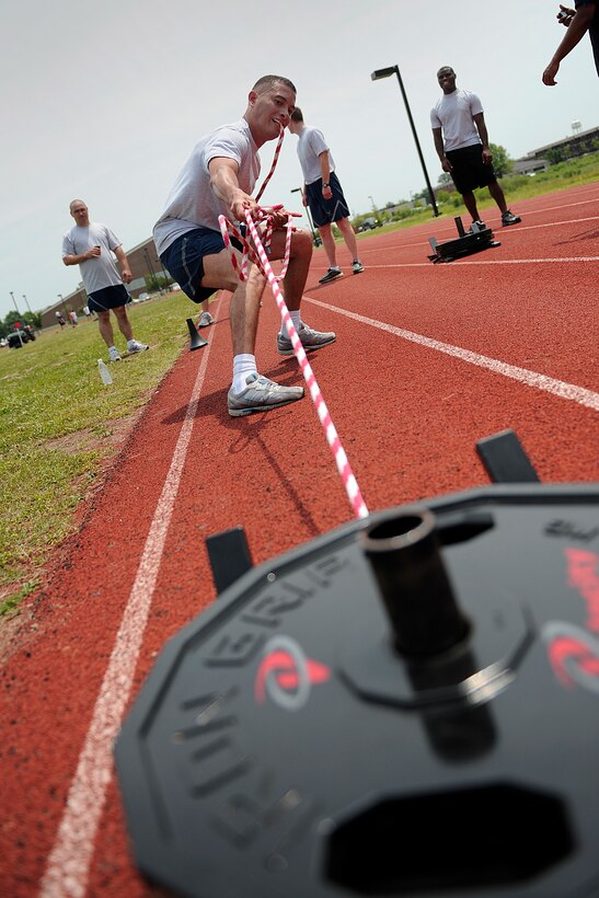LANGLEY AIR FORCE BASE, Va. -- Capt. Carlos Colon, 1st Force Support Squadron force management operations chief, pulls weight during the push and pull station to test core body strength during a Velocity class here May 29.  Certified representatives from Velocity led a physical conditioning class geared toward improving overall physical performance in support of May fitness month.  (U.S. Air Force photo/Senior Airman Vernon Young)