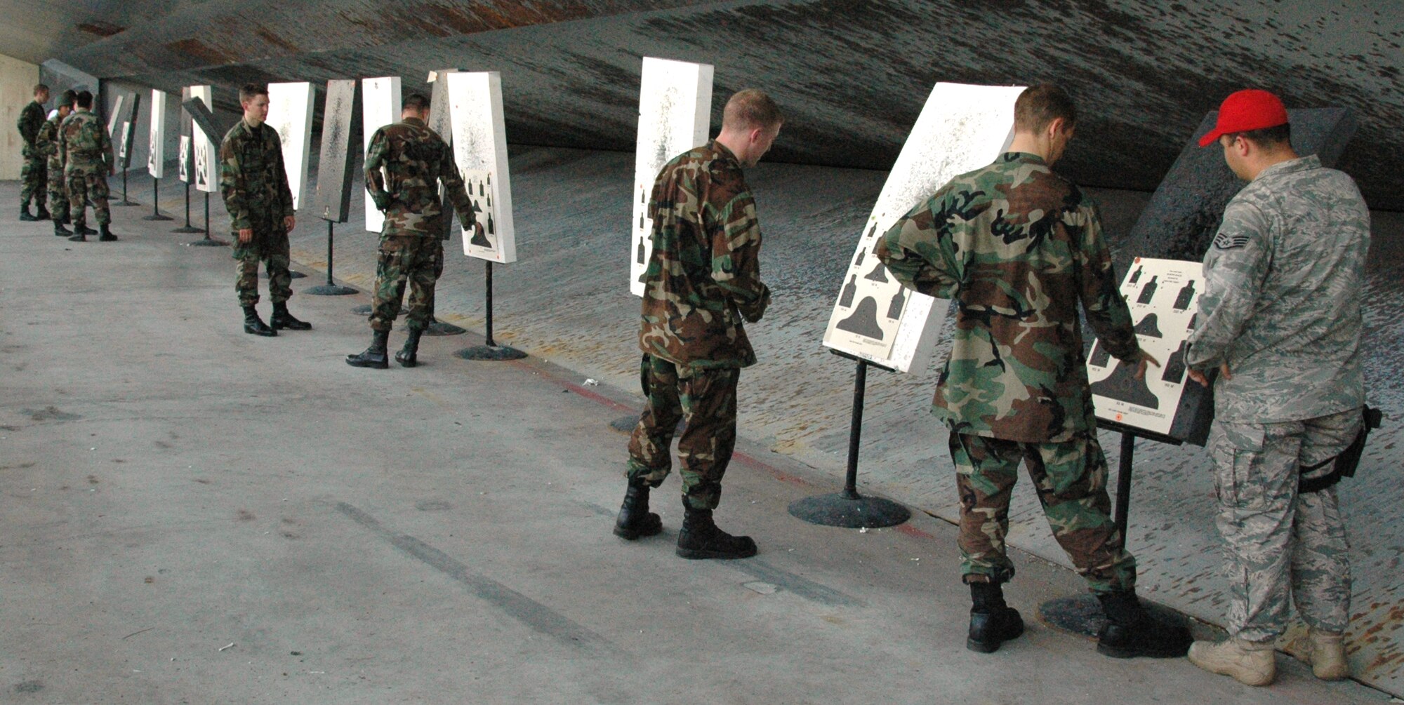 Air Force Academy cadets examine and analyze their targets after firing M-16s under the supervision of Staff Sgt. Jody Tidwell (right), Combat Arms Training and Maintenance instructor, at the 325th Security Forces Squadron’s firing range as a part of Operation Air Force. The Operation Air Force program is a three-week program designed to give cadets the opportunity to experience firsthand everything an operational Air Force base has to offer. (U.S. Air Force photo/1st Lt. Cody Chiles)