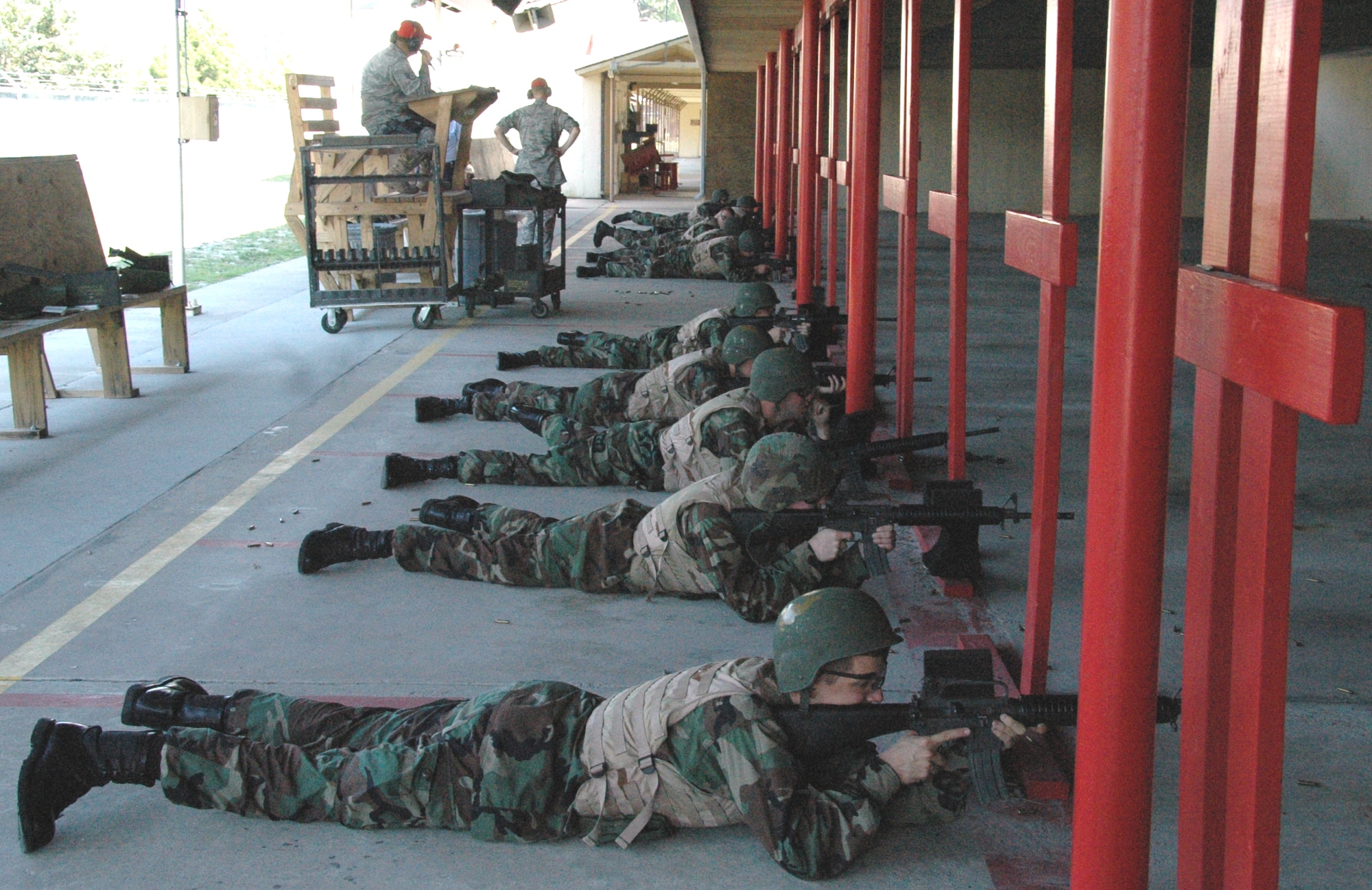 Air Force Academy cadets fire M-16s at the 325th Security Forces Squadron’s firing range under the supervision of Staff Sgt. Jody Tidwell (upper left), Combat Arms Training and Maintenance instructor, as part of Operation Air Force.  Every summer prospective officers from the AFA and the Reserve Officer Training Corps are given the opportunity to go through a three-week program at various Air Force bases to immerse them in the Air Force way of life and assist them in understanding what each career field has to offer. (U.S. Air Force photo/1st Lt. Cody Chiles)