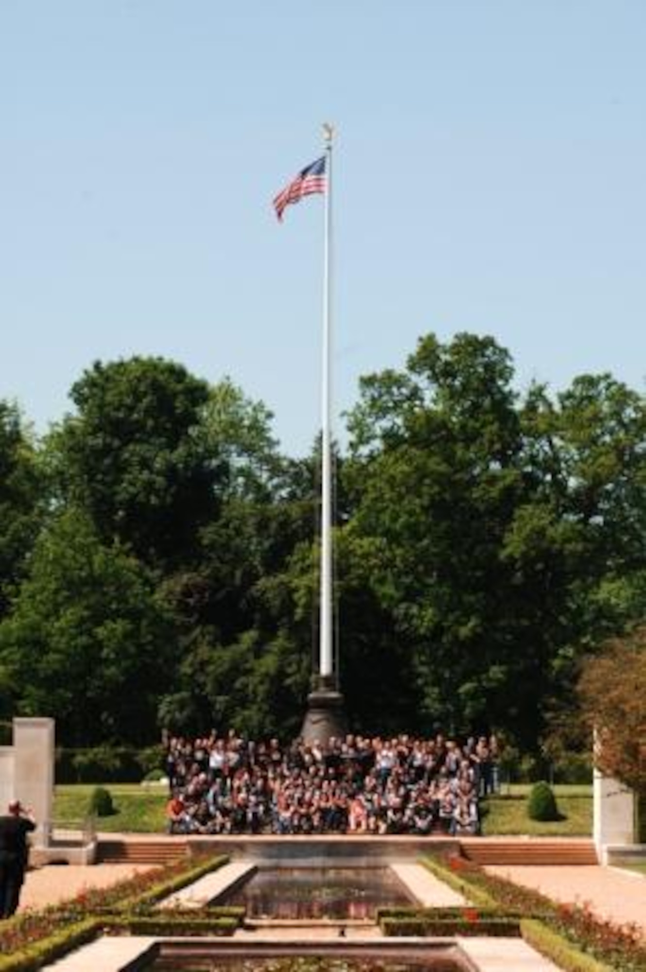 Nene Valley Chapter HOG gather with their banner at the flagpole of the Cambridge American Cemetery.  (U.S. Air Force photo by Staff Sgt. Chad E. Chisholm)