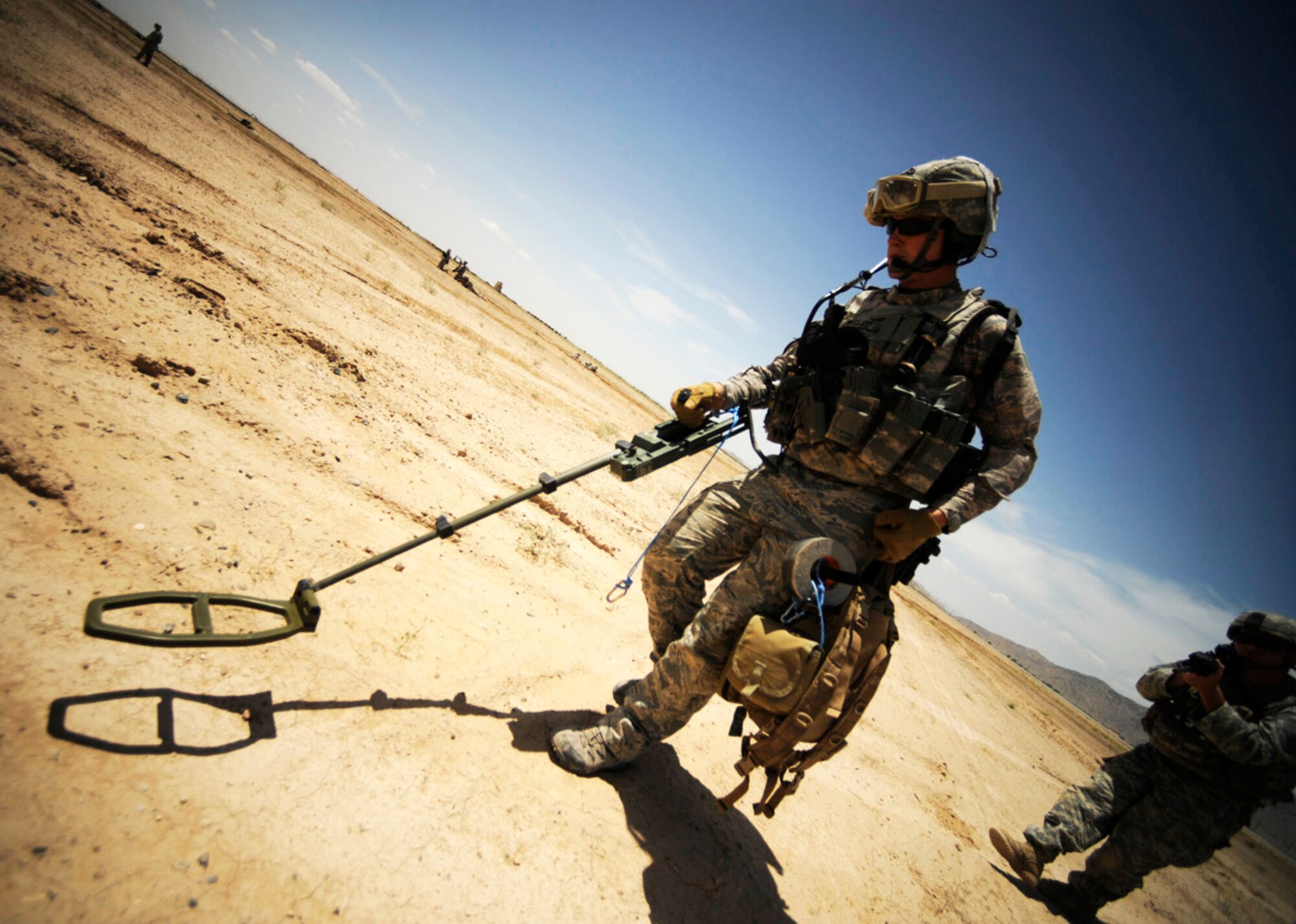 Staff Sgt. Ryan McCleary uses a metal detector to scan for improvised explosives during joint explosive ordnance training May 5 at Kandahar Airfield, Afghanistan. Sergeant McCleary is a 755th Explosive Ordnance Disposal technician. (U.S. Air Force photo/Staff Sgt. James L. Harper Jr.) 
