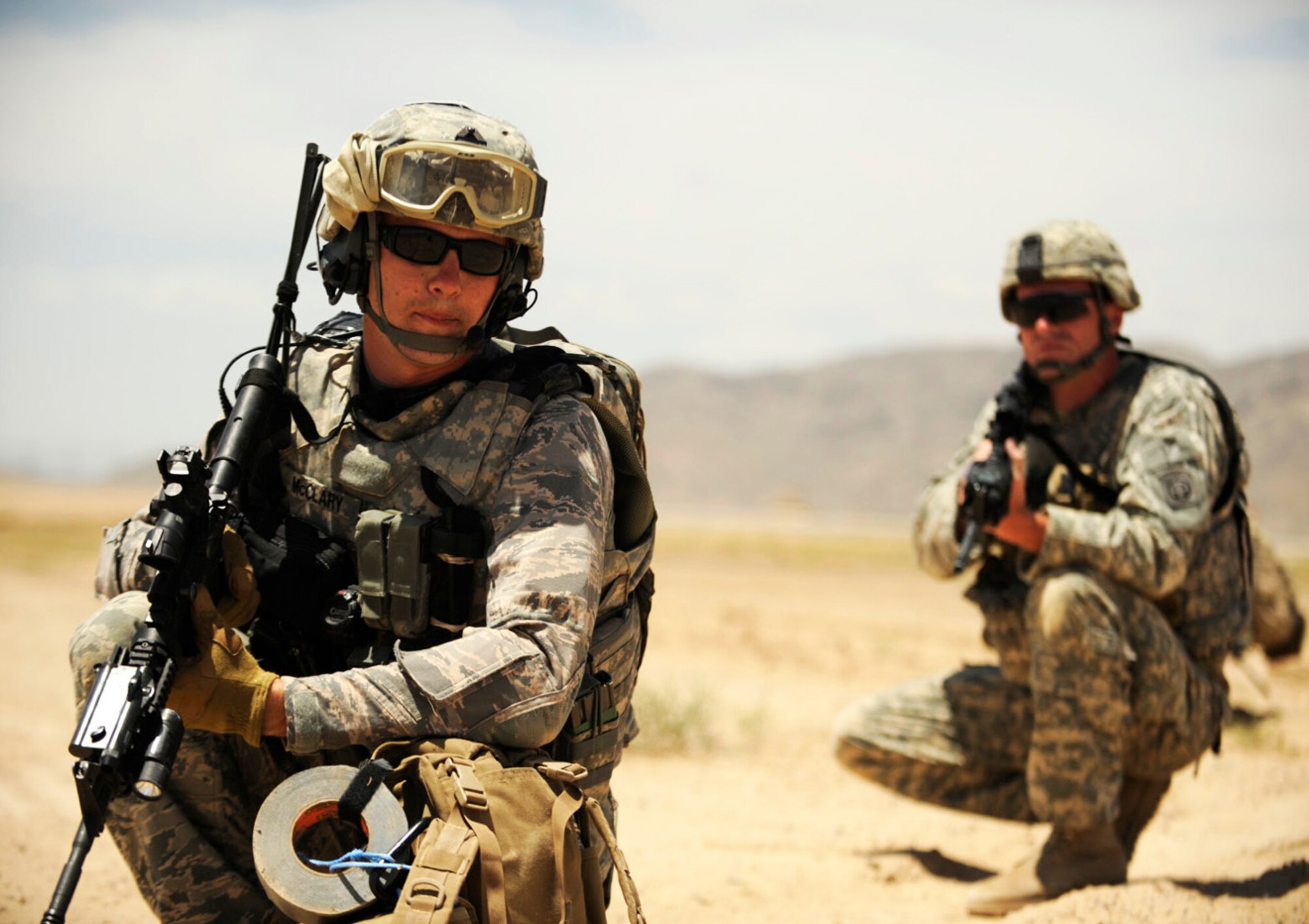Staff Sgt. Ryan McCleary relays a message to Army Sgt. Mike Ridgeway during joint explosive ordnance training May 5 at Kandahar Airfield, Afghanistan. Sergeant McCleary is a 755th Explosive Ordnance Disposal technician, and Sergeant Ridgeway is an infantryman from the 82nd Airborne. (U.S. Air Force photo/Staff Sgt. James L. Harper Jr.) 
