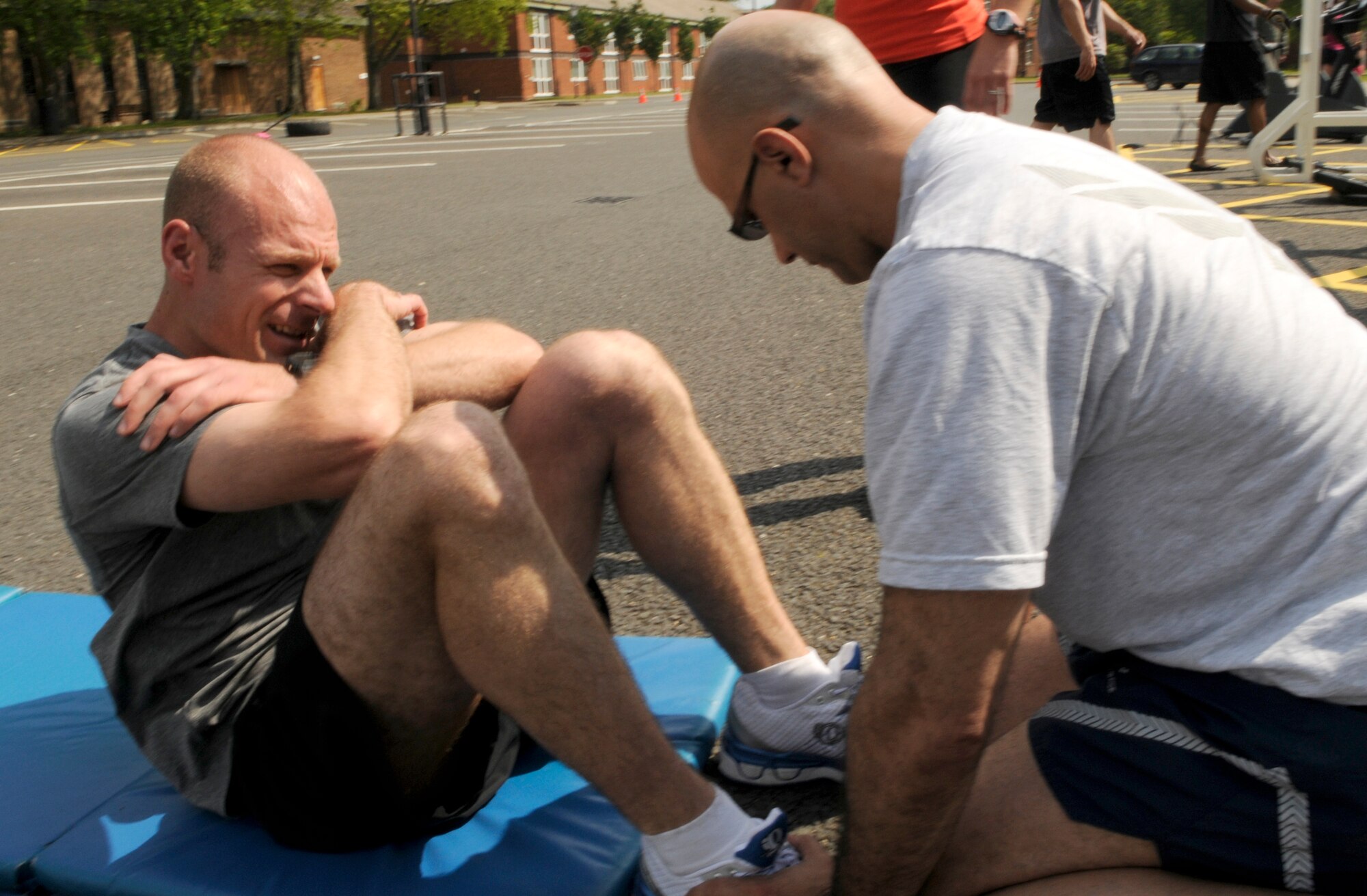 Lt. Col. John Rau from the 100th Air Refueling Wing Plans and Programs Section, Turns out some sit-ups as part of the Box D challenge at the fitness expo on RAF Mildenhall May 29.  The Box D challenge tests athletes' ability to perform several different exercises in row for an overall time.  (U.S. Air Force photo by Staff Sgt. Christopher L. Ingersoll)