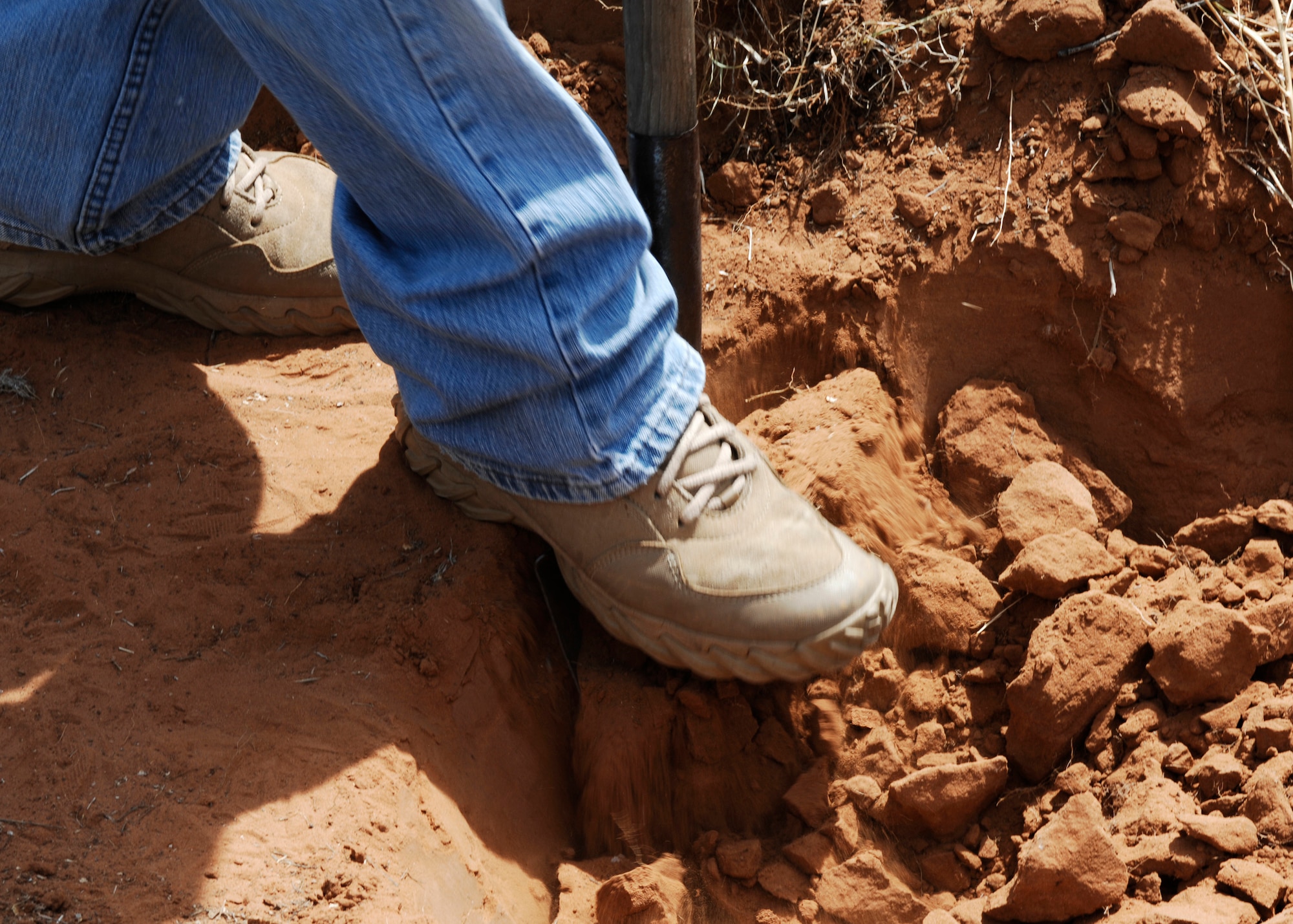 CANNON AIR FORCE BASE, N.M. -- Base Airmen cautiously dig into the red New Mexico soil as they begin work May 29-30 to restore Blacktower Cemetery, which borders Cannon. The project could last until Memorial Day 2010. (U.S. Air Force photo by Greg Allen)