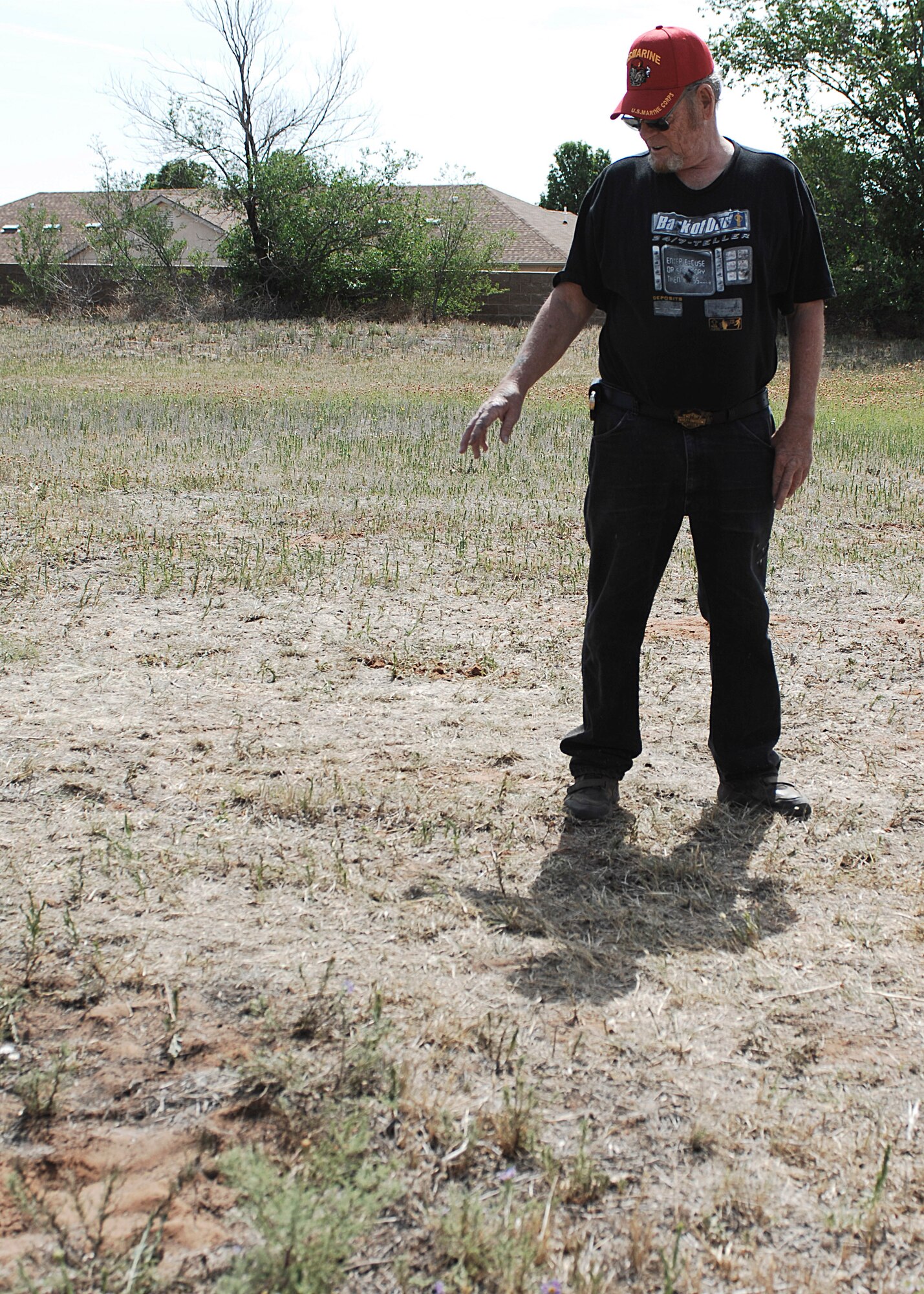 CANNON AIR FORCE BASE, N.M. -- Dennis Winn, a Clovis, N.M., resident, walks through Blacktower Cemetery,looking for clues to learn where his great-great grandfather, Civil War veteran Emmett Fulkerson, was buried. Cannon Airmen began a project May 29-30 to restore the abandoned cemetery that lies adjacent to the base. (U.S. Air Force photo by Greg Allen) 