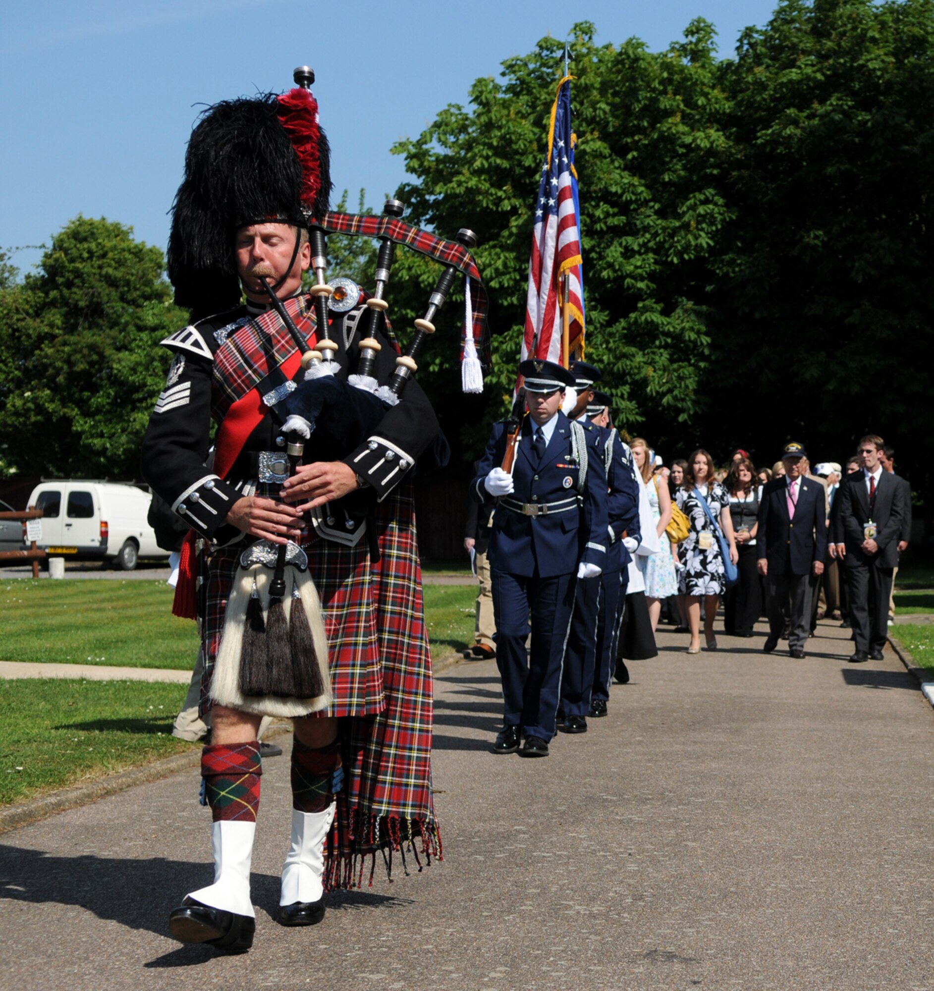 Bagpiper Dave Harper, followed by the RAF Mildenhall Honor Guard, leads a precession of World War II veterans, students and faculty members from Missouri’s College of the Ozarks to a ceremony at Thorpe Abbots, the former home of the 100th Bomb Group.  The group was in England on a tour of historic World War II sites coinciding with the 65th anniversary of the Allied invasion of occupied France.  (U.S. Air Force photo by Staff Sgt. Austin M. May)