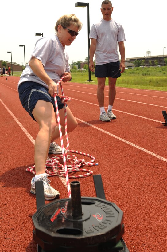 LANGLEY AIR FORCE BASE, Va. -- 1st Force Support Squadron commander Lt Col. Caroline Miller pulls weights during the sled pull and push portion of the ultimate velocity challenge here May 29. The challenge was held for May fitness month as volunteers tested their muscular endurance and agility.  (U.S. Air Force photo/Senior Airman Ashley Hawkins)
