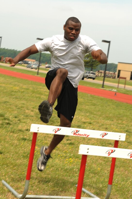 LANGLEY AIR FORCE BASE, Va. -- Airman 1st Class Justin Reed, fitness specialist with 1st Force Support Squadron, jumps over a hurdle during the obstacle course portion of the ultimate velocity challenge here May 29. The challenge was held for May fitness month as volunteers tested their muscular endurance and agility. (U.S. Air Force photo/Senior Airman Ashley Hawkins)