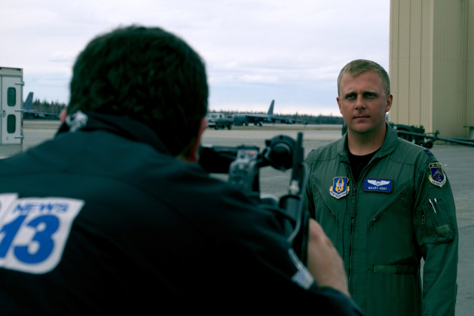 Capt. Maury Kent, standardization and evaluation officer, 93rd Bomb Squadron, Barksdale Air Force Base, La., answers questions posed by Will Driscoll with Fairbanks' CBS Channel 13 (KXD-TV) at a media event, May 4, 2006, during RED FLAG - Alaska 06-2 at Eielson Air Force Base, Alaska.  The event allowed local media to meet with representatives of units involved in RF-A 06-2 before boarding a KC-10 Extender for a familiarization flight. (U.S. Air Force photo/Tech. Sgt. Jeff Walston)