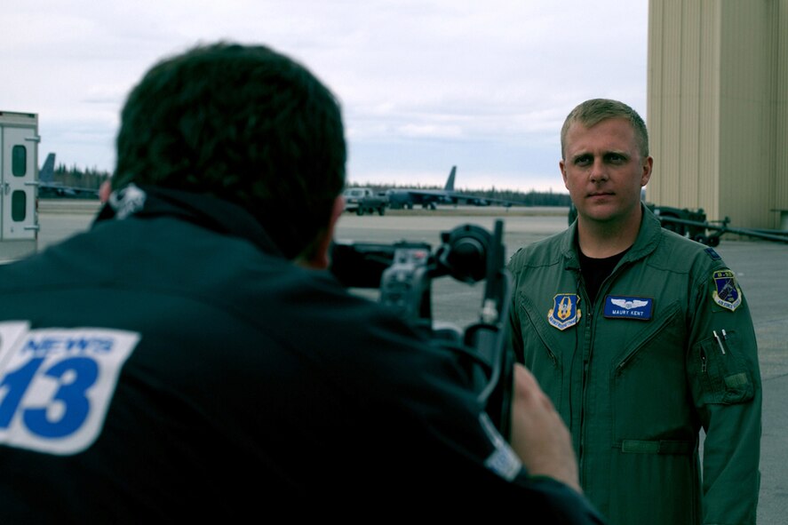 Capt. Maury Kent, standardization and evaluation officer, 93rd Bomb Squadron, Barksdale Air Force Base, La., answers questions posed by Will Driscoll with Fairbanks' CBS Channel 13 (KXD-TV) at a media event, May 4, 2006, during RED FLAG - Alaska 06-2 at Eielson Air Force Base, Alaska.  The event allowed local media to meet with representatives of units involved in RF-A 06-2 before boarding a KC-10 Extender for a familiarization flight. (U.S. Air Force photo/Tech. Sgt. Jeff Walston)