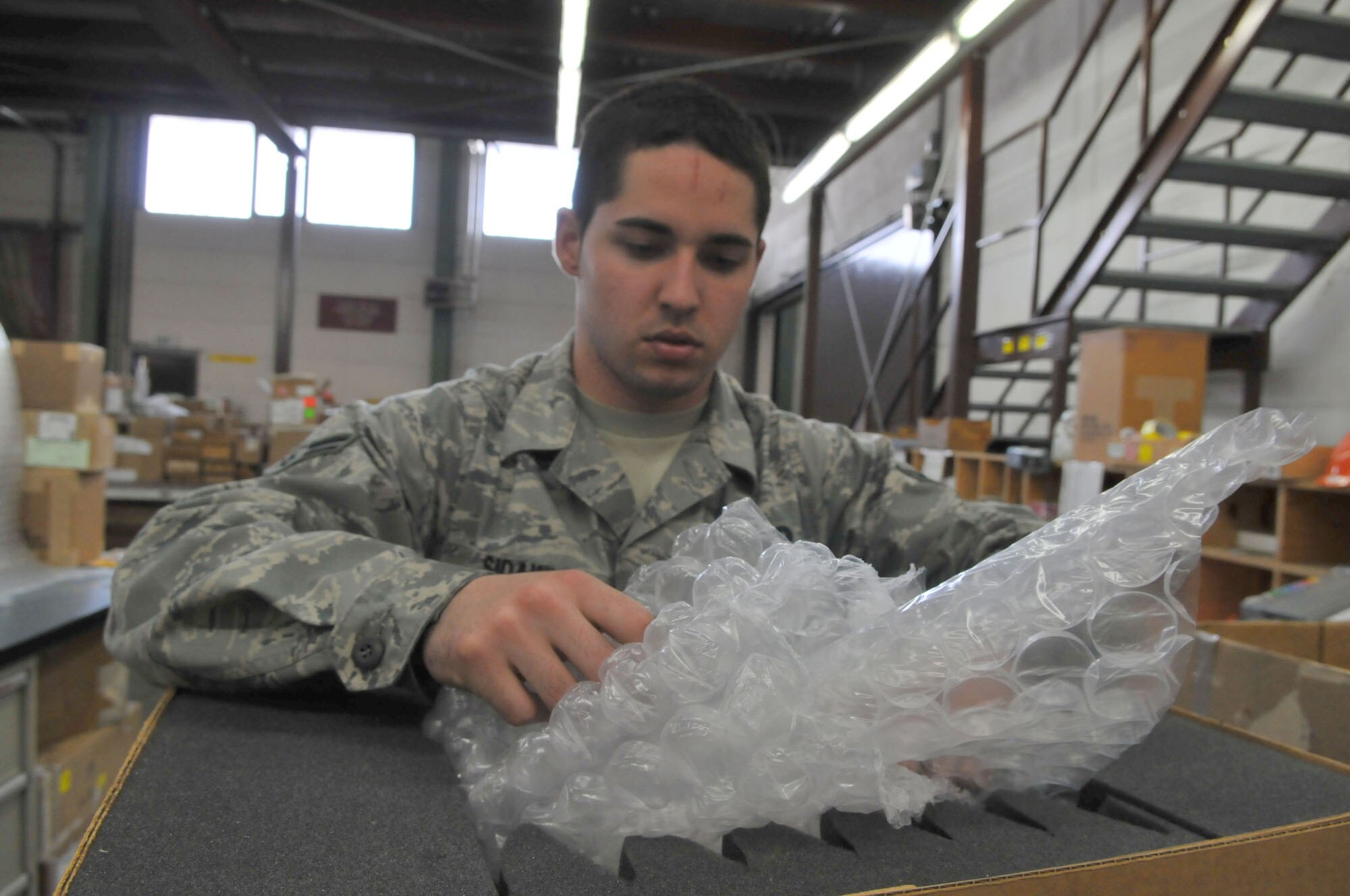 SPANGDAHLEM AIR BASE, Germany – Airman 1st Class Ryan Sidawi, 52nd Logistics Readiness Squadron travel management office, prepares  cargo for out-processing and shipment. The TMO office is open 8 a.m. – 4 p.m. Monday through Friday. (U.S. Air Force photo by Airman 1st Class Nick Wilson)